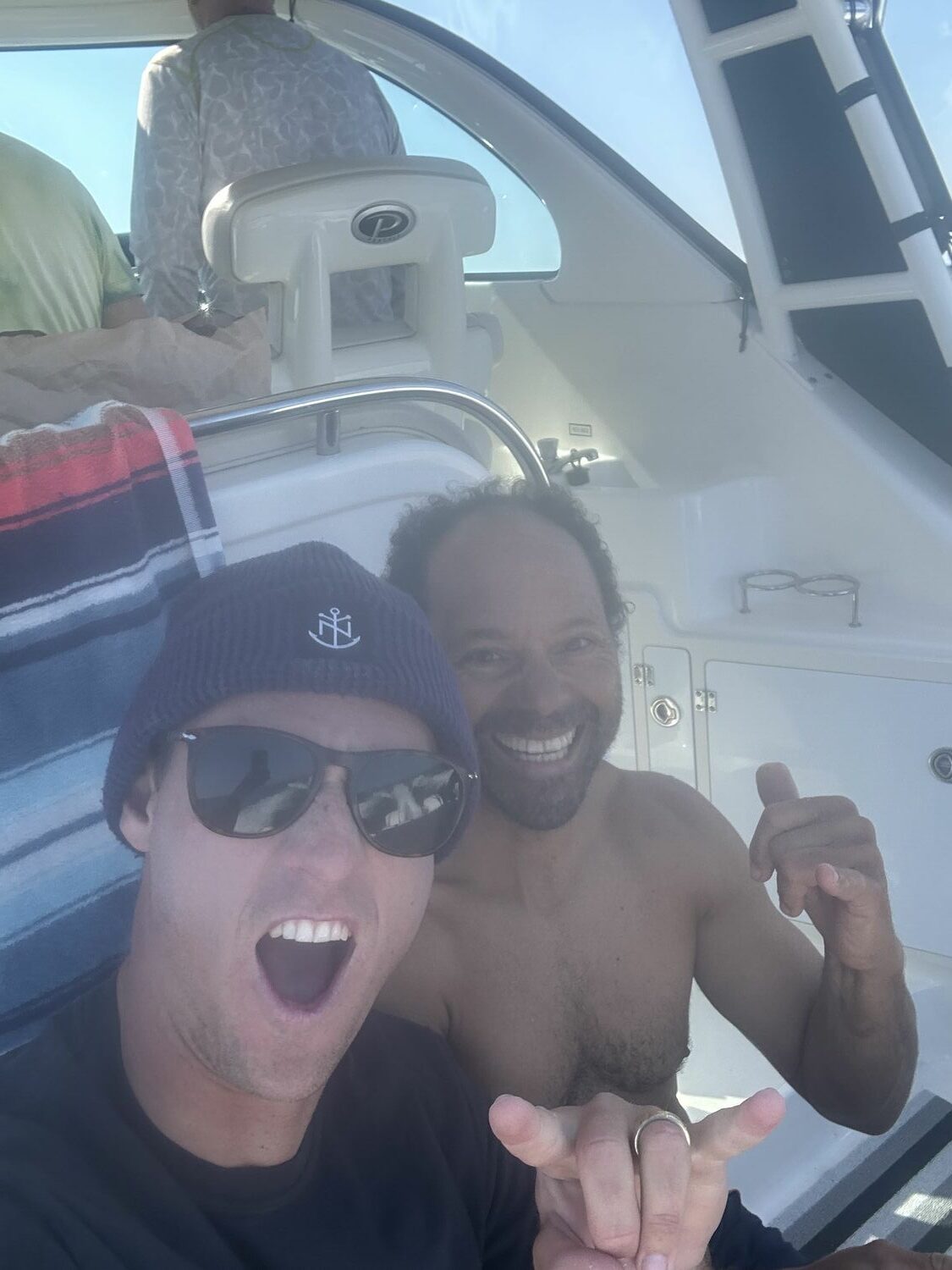 Drew Harvey, left, and Jeremy Grosvenor celebrate on the support boat. COURTESY DAWGPATCH BANDITS