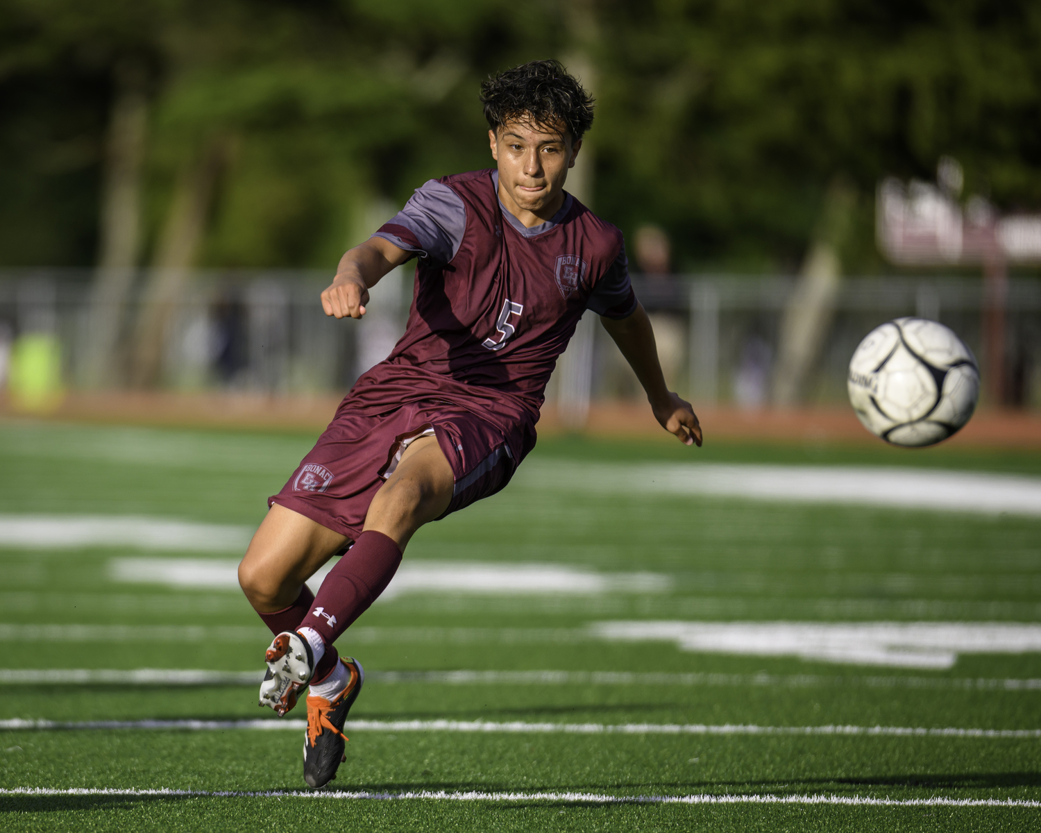 East Hampton junior Johan Chacon sends the ball with his left foot.  MARIANNE BARNETT