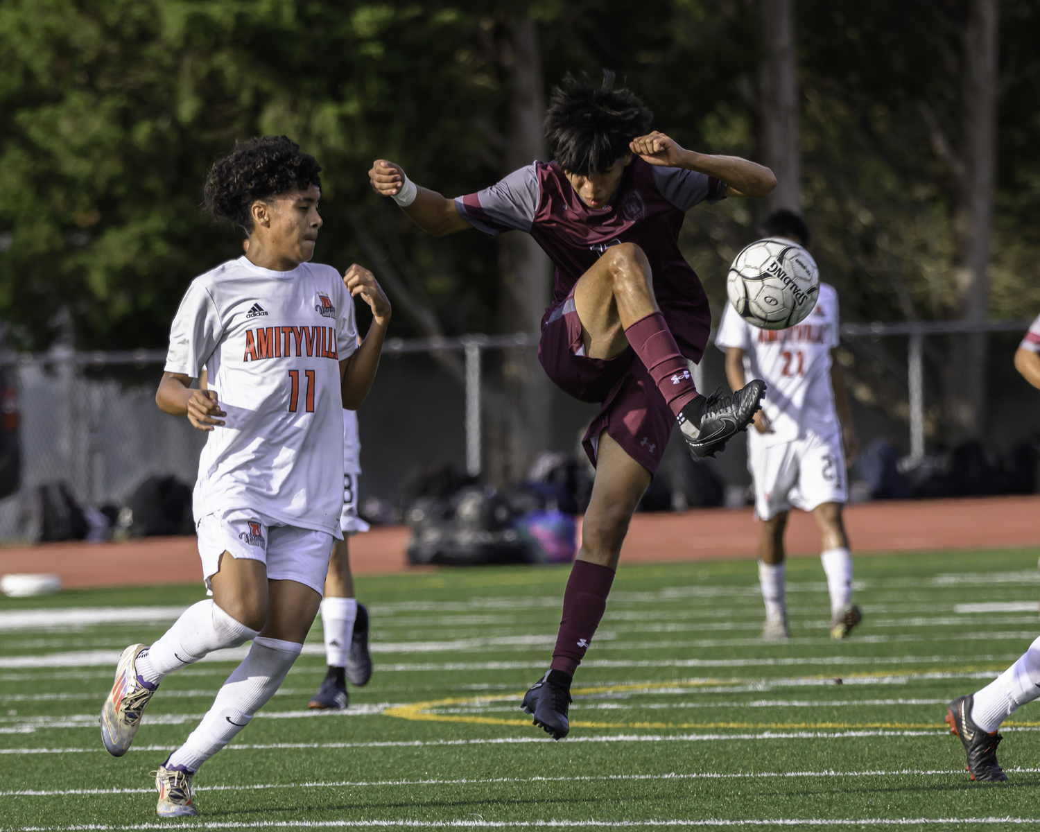 East Hampton senior Michael Chimbo settles the ball down with his foot.  MARIANNE BARNETT