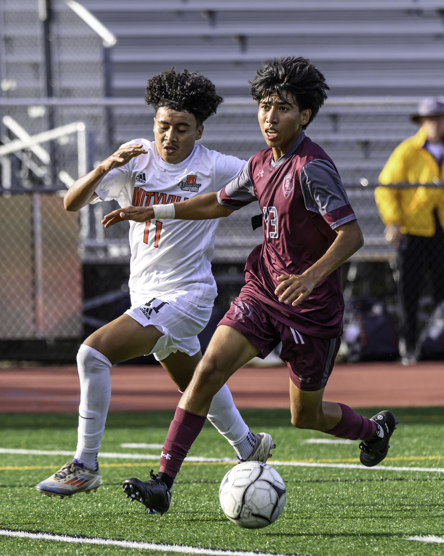 East Hampton senior Michael Chimbo brings the ball downfield while looking for an open teammate.   MARIANNE BARNETT