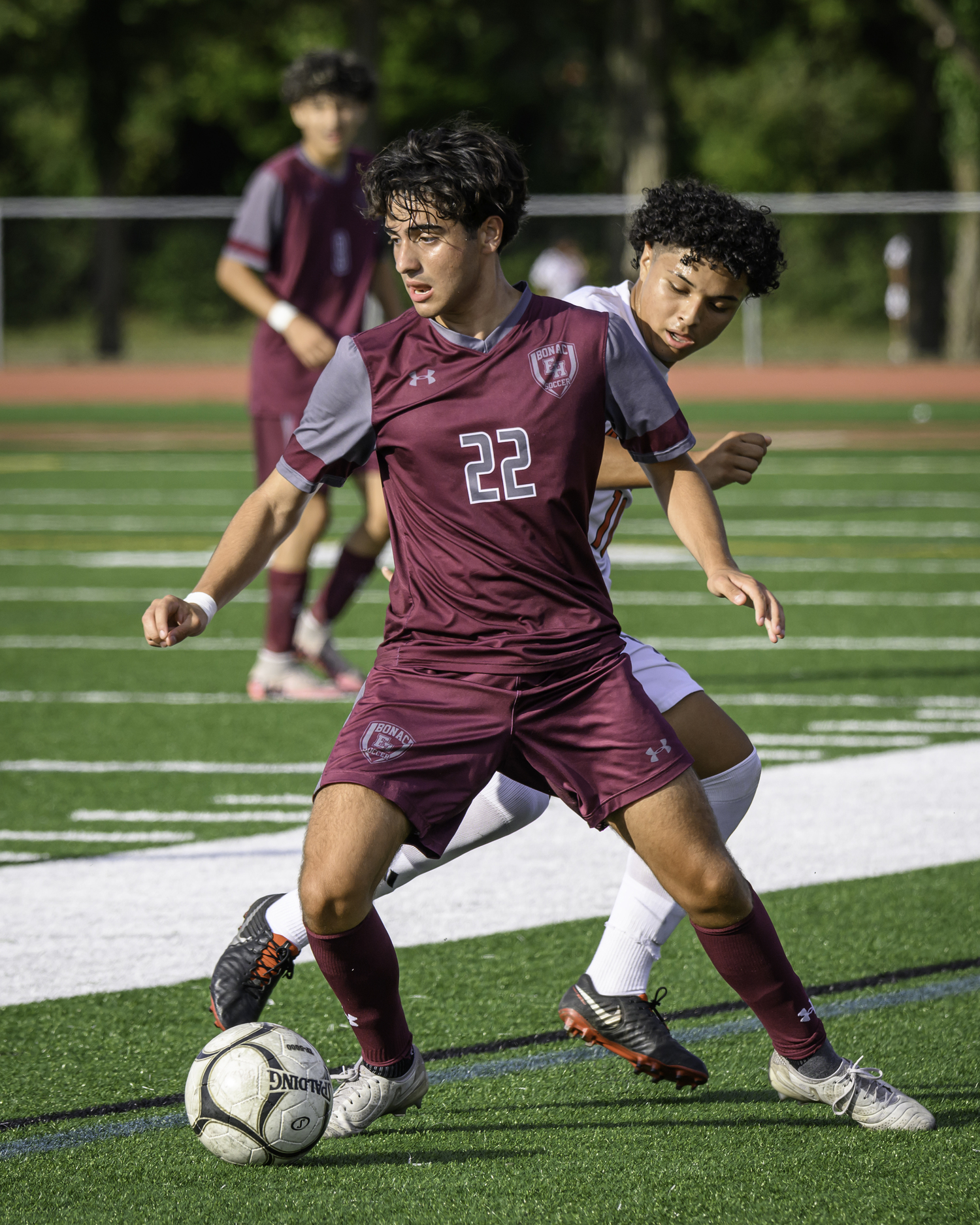 East Hampton senior Diego Duke fends off an Amityville player.   MARIANNE BARNETT