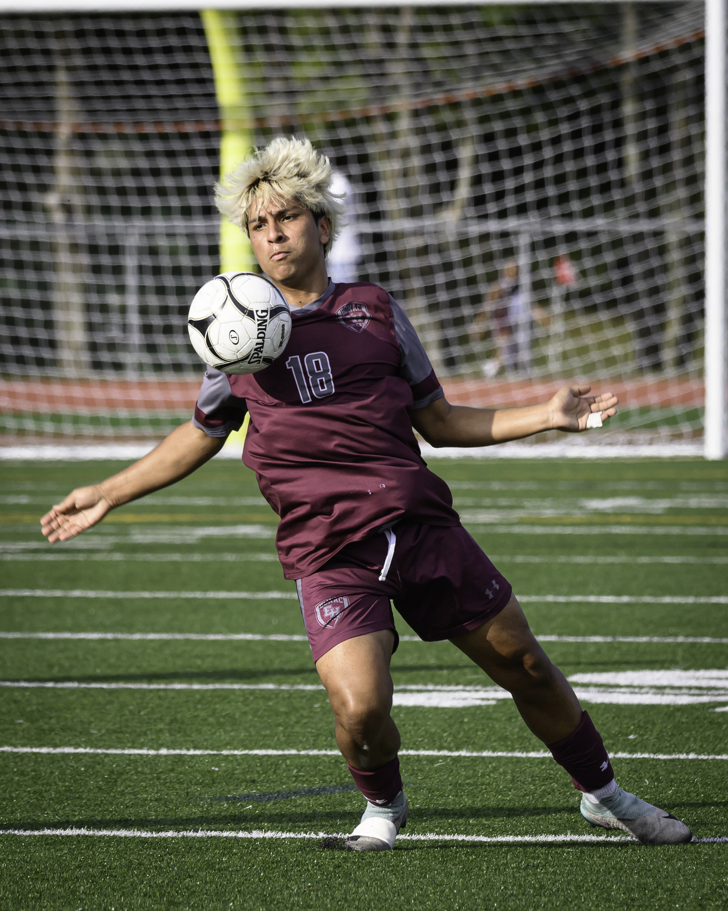 East Hampton senior Juan Salcedo plays the ball off his chest.   MARIANNE BARNETT