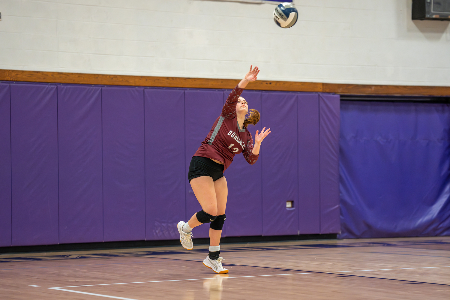 Senior Mackenzie Lenahan serves.  RON ESPOSITO