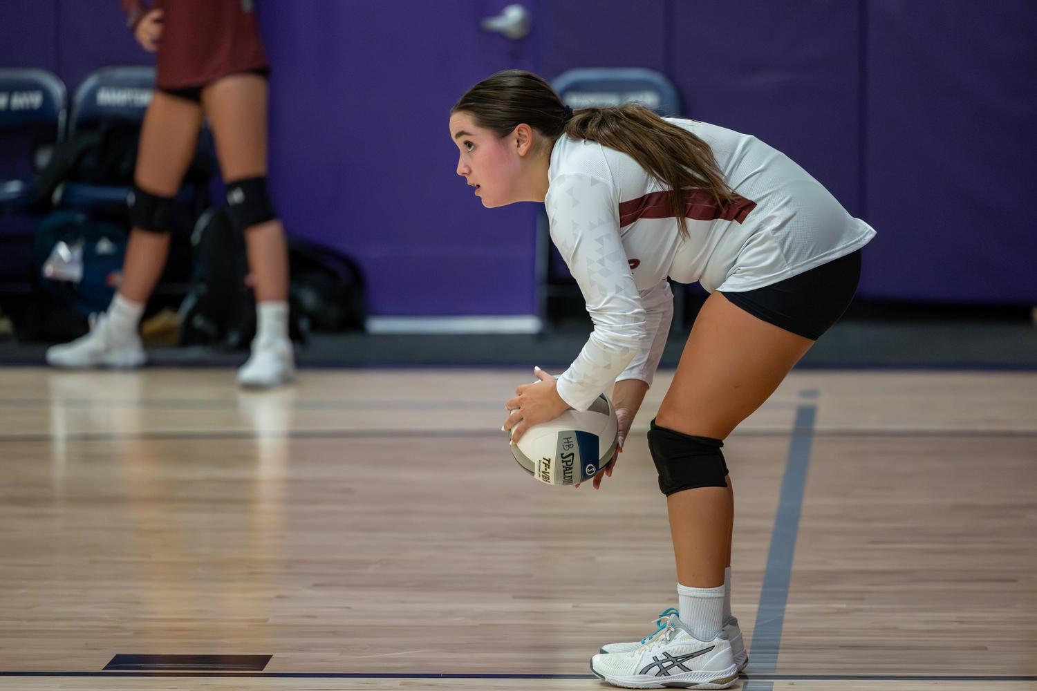 Senior Julia Kuneth gets set to serve.  RON ESPOSITO