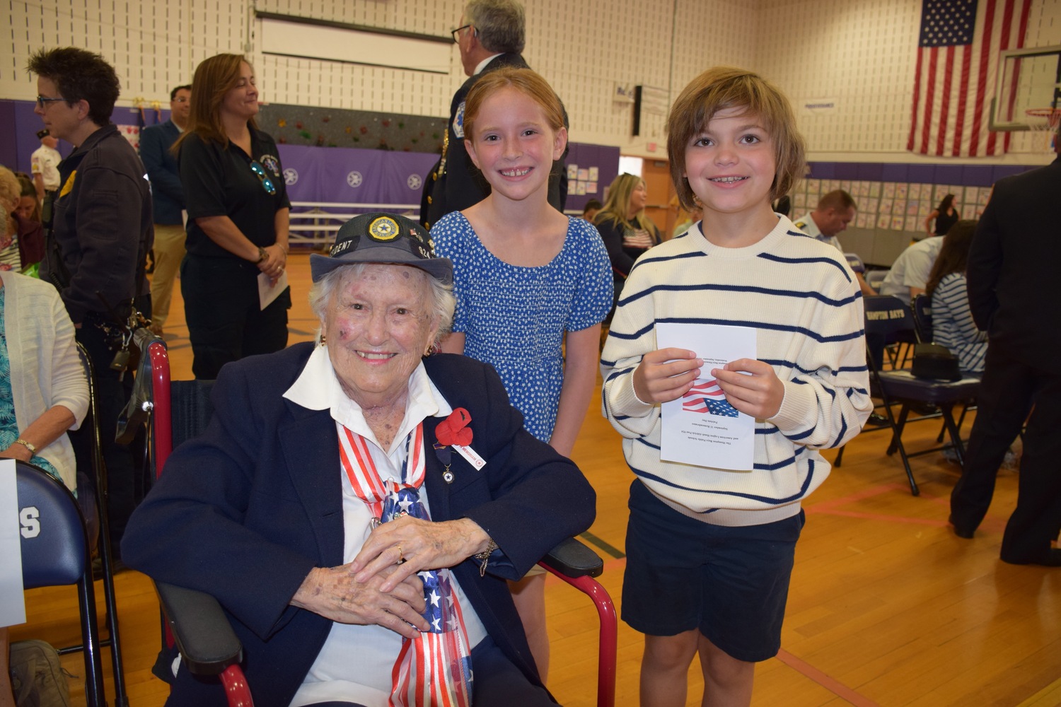 he Hampton Bays School District honored Sylvia Catena Smith, an active member of the Hampton Bays American Legion Auxiliary, during a ceremony on September 11. Among the students participating in the celebration were fourth graders Rylan Clemensen and Lyla Holden. COURTESY HAMPTON BAYS SCHOOL DISTRICT