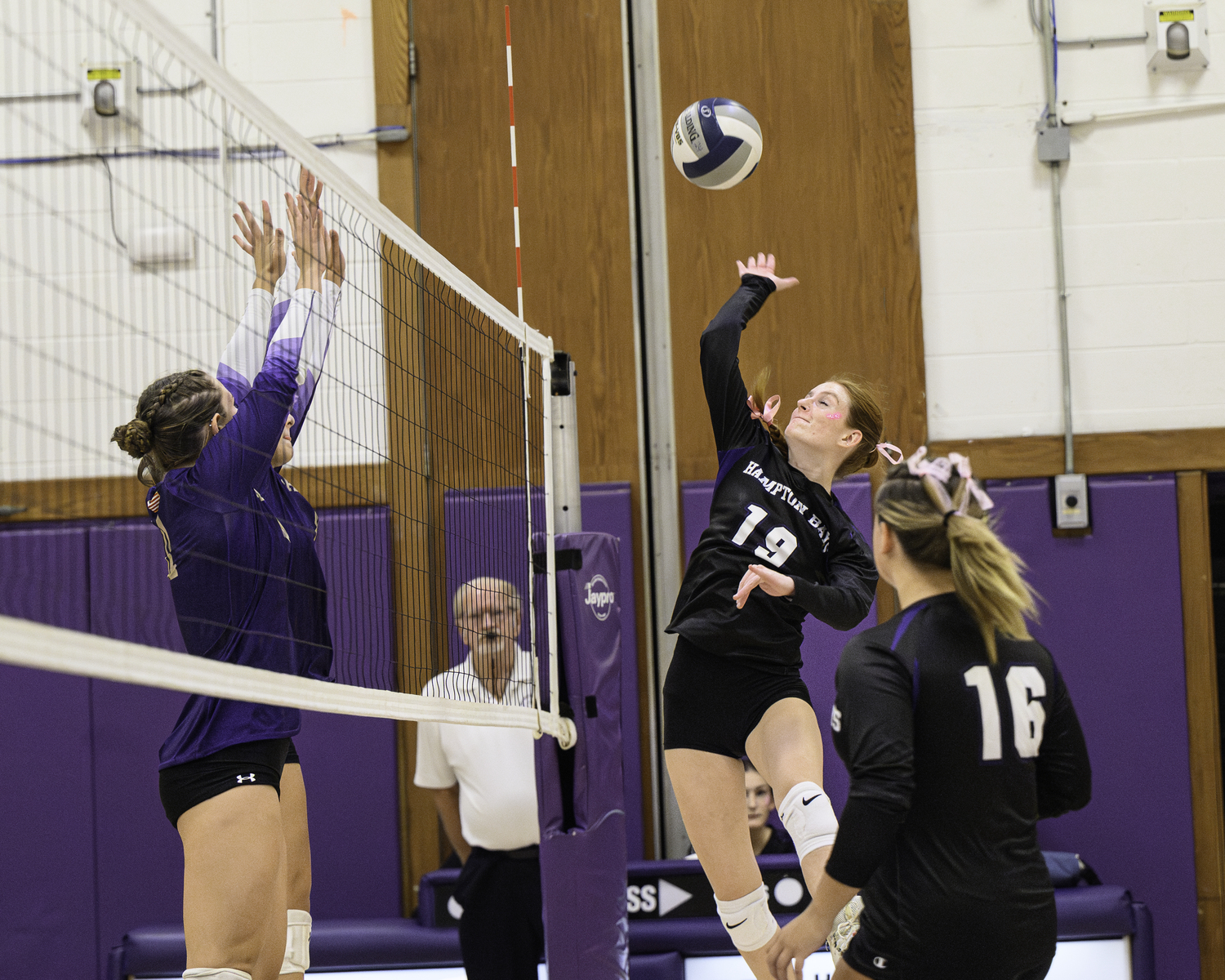 Junior middle blocker Shea Egan knocks the ball back over the net. MARIANNE BARNETT