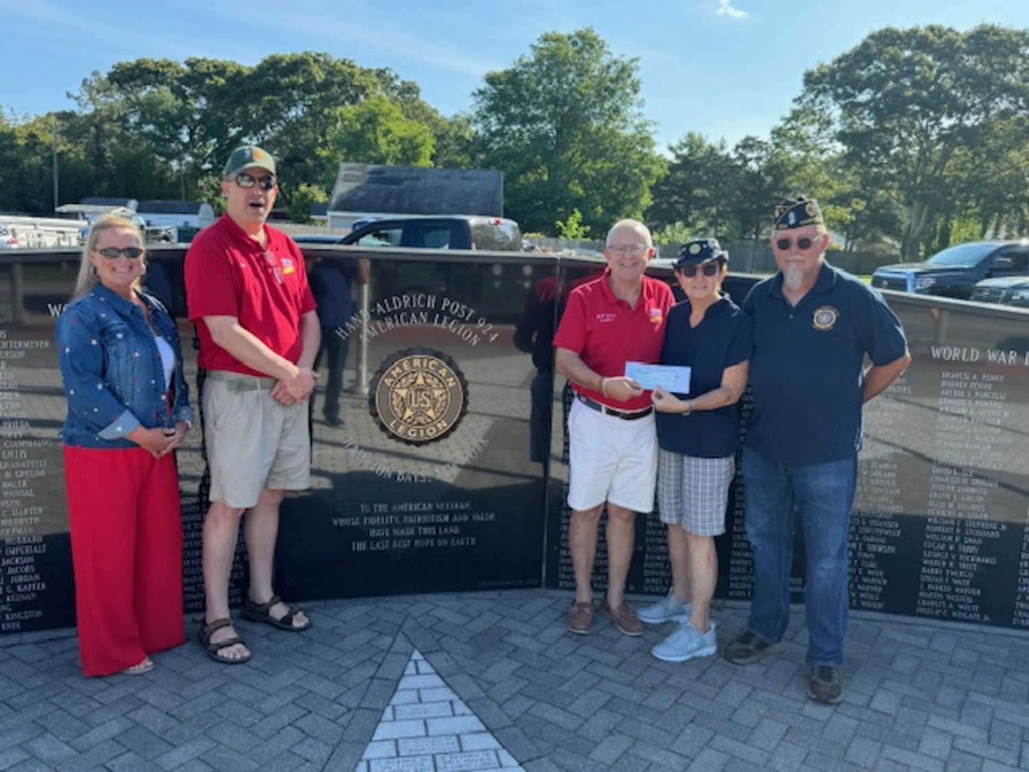 Bill Jones, president of Honor Flight Long Island, recently received a check for $800 from Hampton Bays Hand Aldrich American Legion Auxiliary Unit 924 President Pamela Ryan.  At the presentation were, from left, Liz Pothier, Secretary of Auxiliary; Bill Donohue, Honor Flight Board Member, Bill Jones, Pam Ryan and George Hand, Commander of Hand Aldrich American Legion.  The donation will cover the cost of two veterans to be honored on a future Honor Flight to Washington D.C. COURTESY BILL JONES