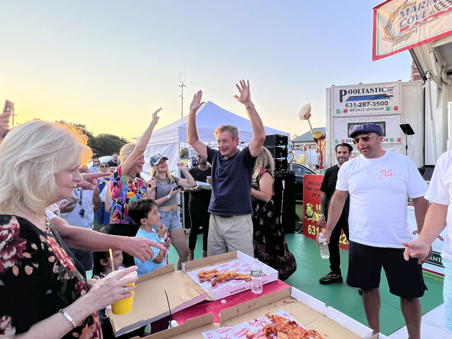 Chris Scull of Hampton Bays wins the pizza eating contest at the San Gennaro Feast of the Hamptons on Saturday.