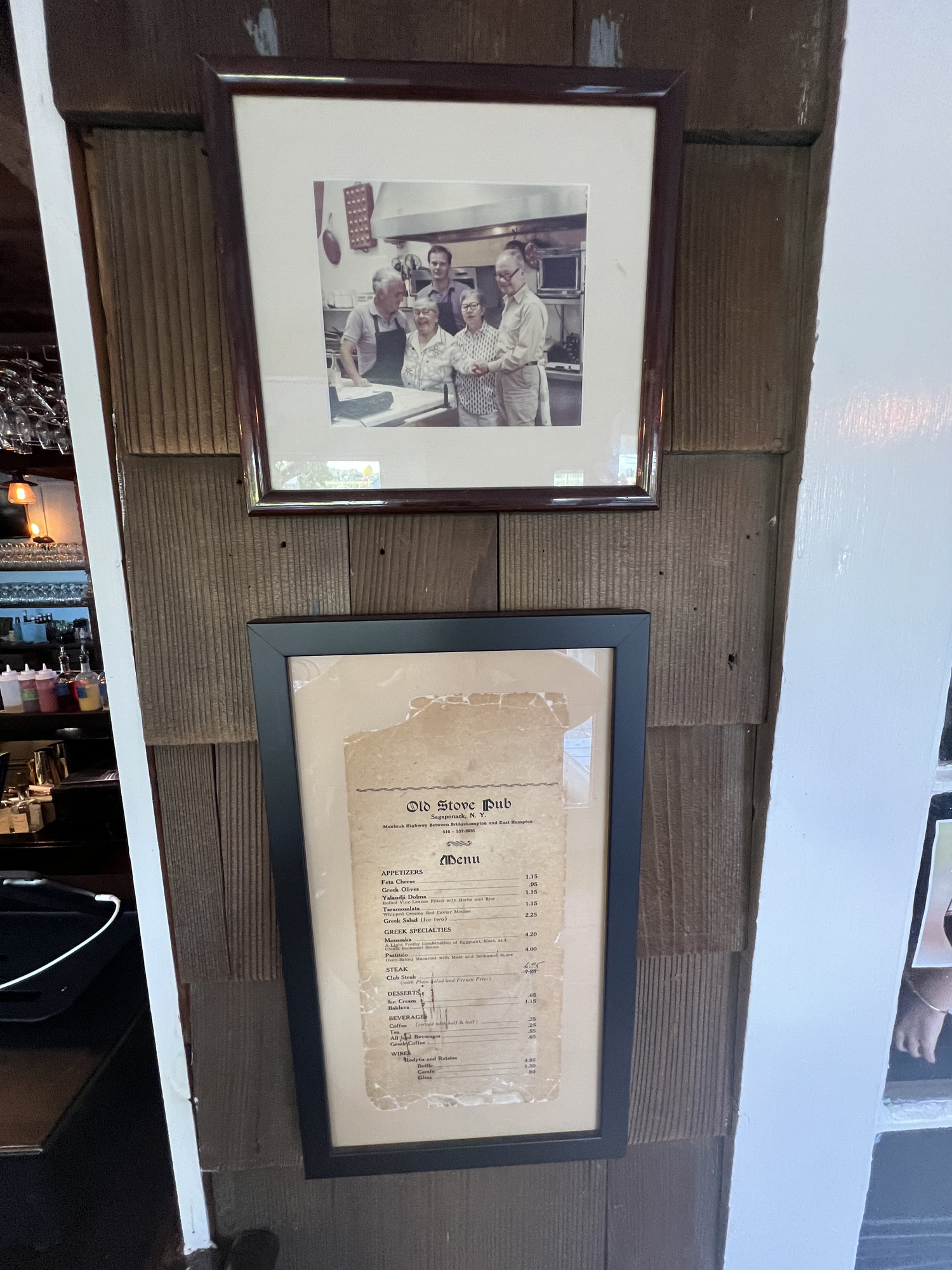 A  framed photo of long-time owners the Johnides family at the pub's first menu.   DANA SHAW