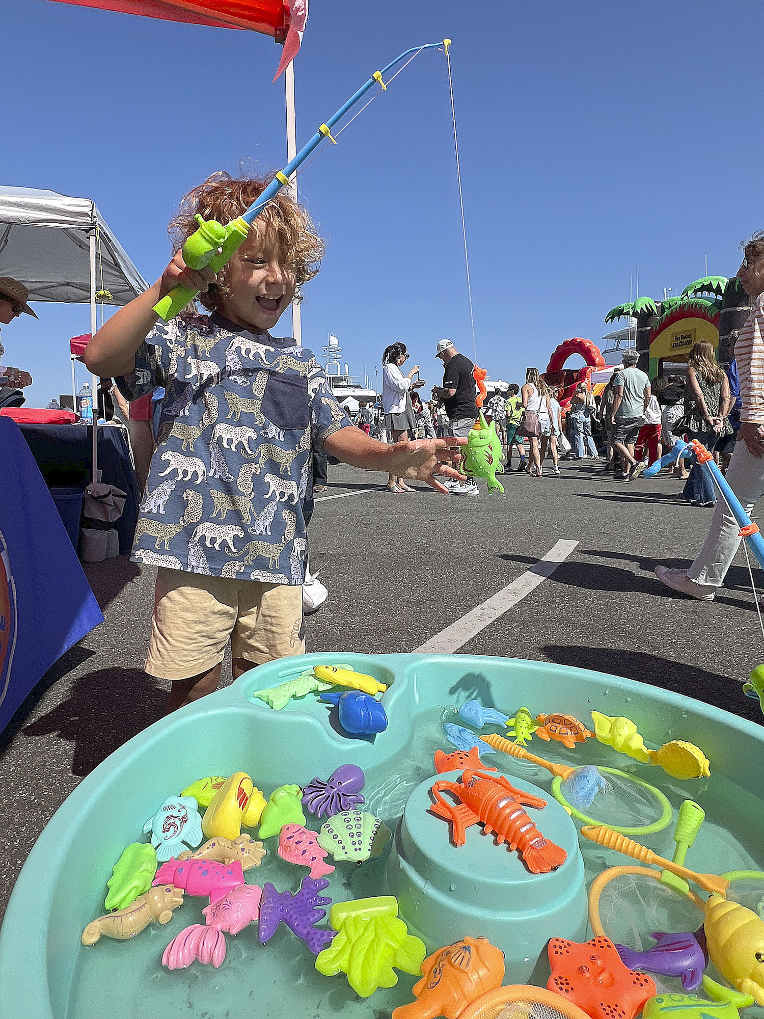 Uviha Gavietto goes fishing at the Fighting Chance booth at HarborFest on Sunday.   DANA SHAW