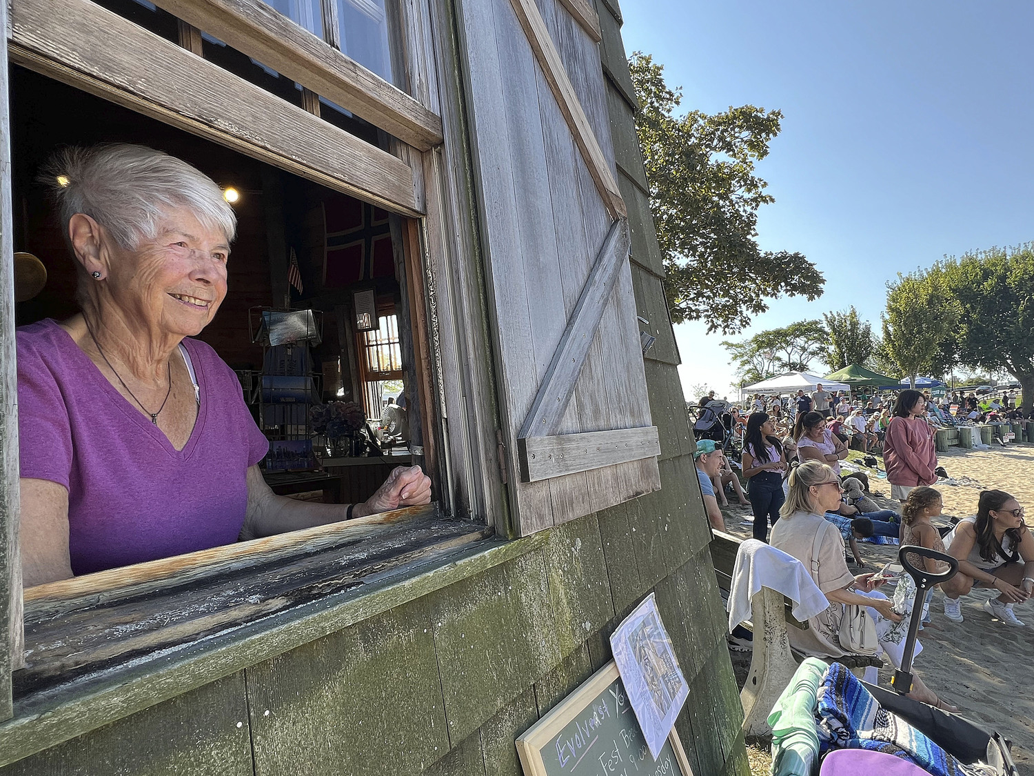 Gillian Kluge watches the activities during HarborFest from the window of the windmill on Sunday afternoon.  DANA SHAW