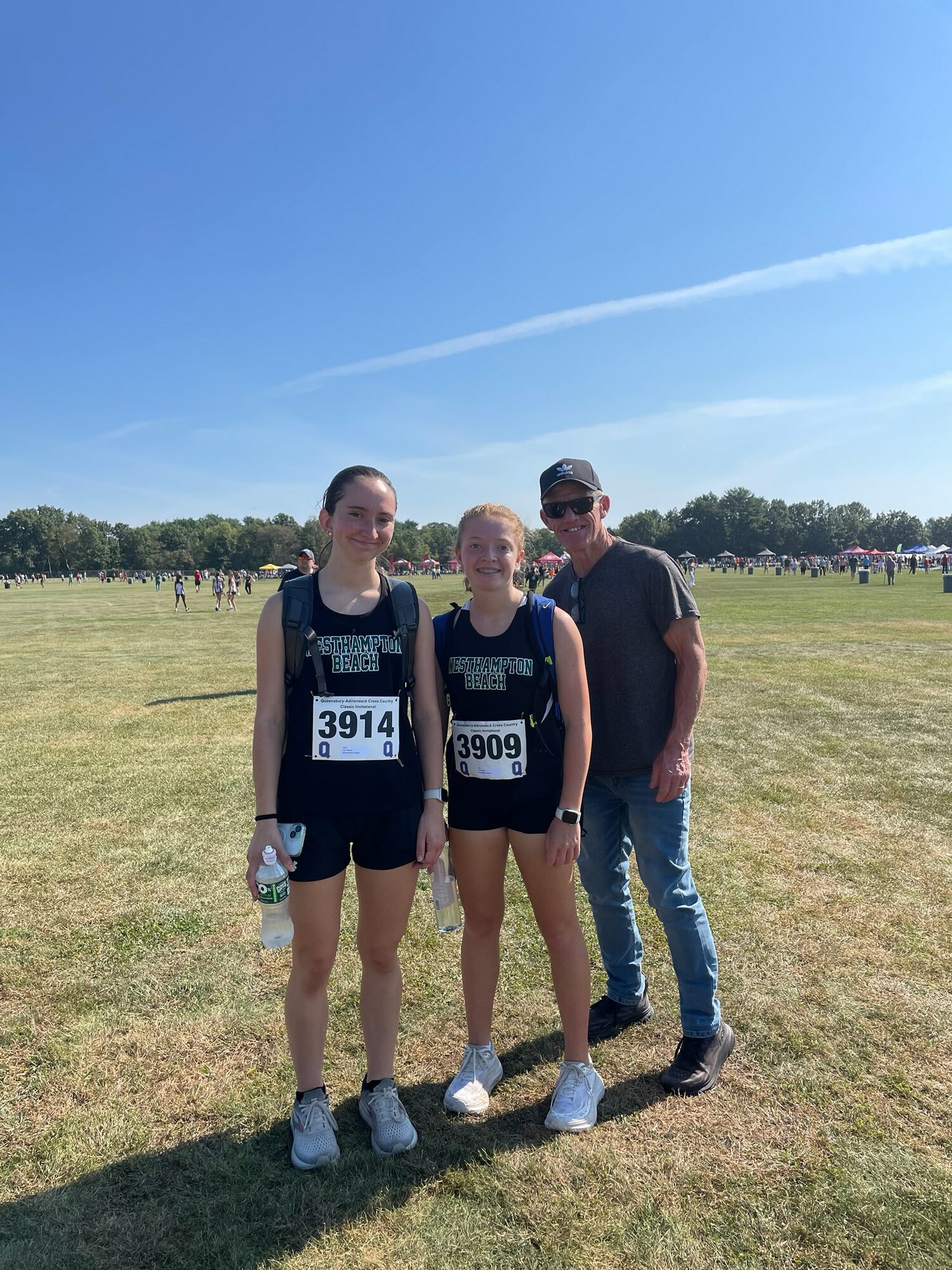 Lily Strebel, left, Fina DiBiaso and head coach John Broich.