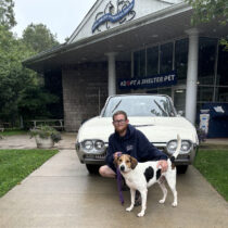 Southampton Animal Shelter Foundation kennel attendant Chris Schmidt with Austin, who is available for adoption at the shelter, in front of the 1962 T-Bird he won at auction. COURTESY CHRIS SCHMIDT