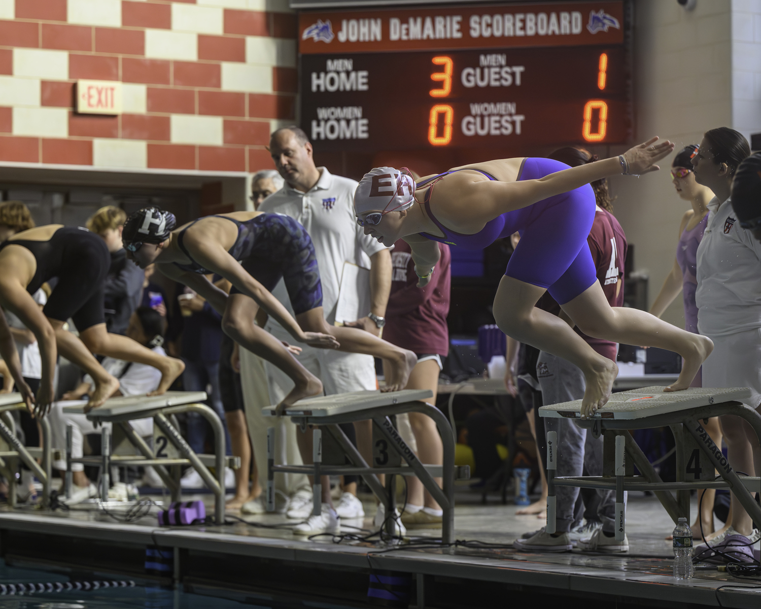 East Hampton junior Lizzy Daniels jumps into the pool during the Suffolk County Championships last season. MARIANNE BARNETT