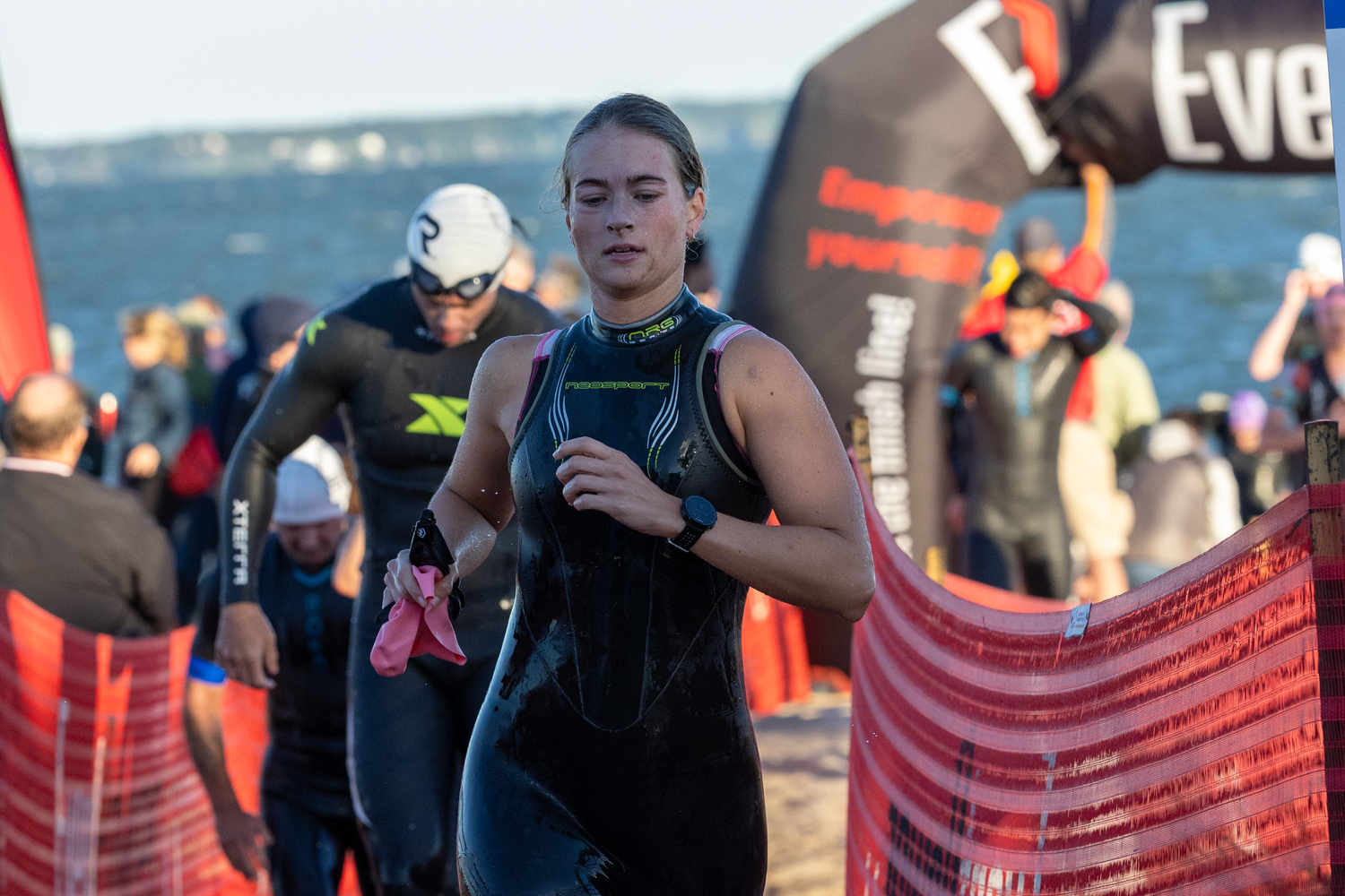 A triathlete heads into a transition area after completing the swim.  RON ESPOSITO