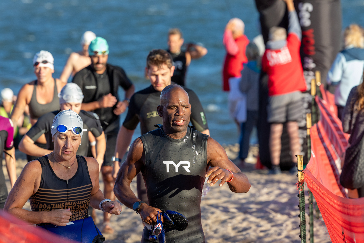 Triathletes head out of the water at Long Beach and transition to the bike portion of Sunday morning's race.   RON ESPOSITO