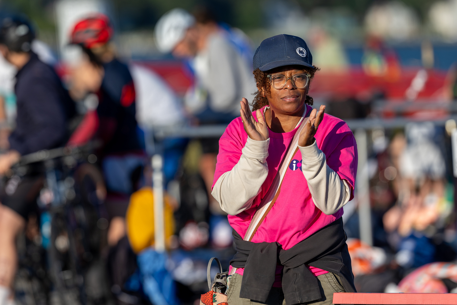 Tara Coady, working as a a volunteer on Sunday morning, cheers the triathletes on.   RON ESPOSITO