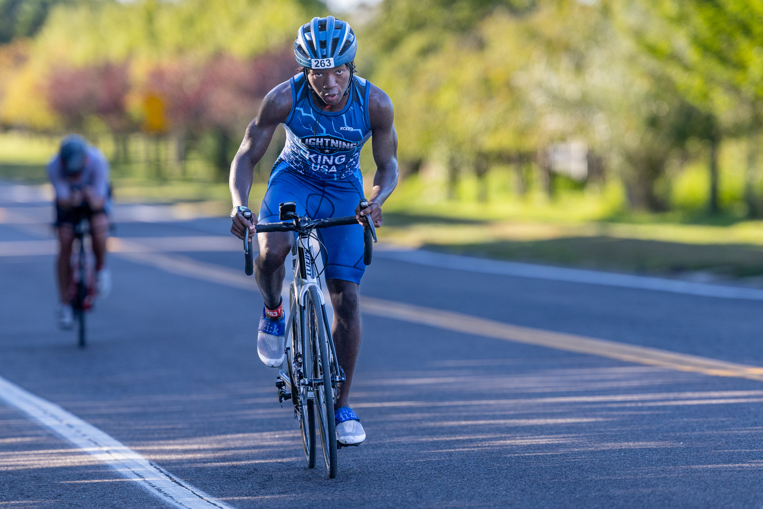 Anthony King of Brooklyn pushes himself in the bike portion of the triathlon. He was first in his male 14-18 age group. RON ESPOSITO