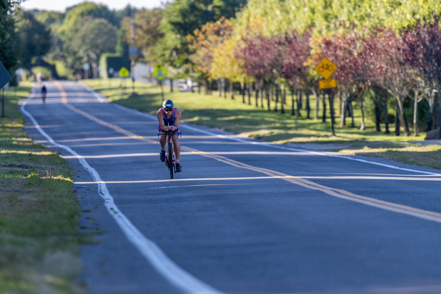 Travis Miranda biking the streets of Sag Harbor during Sunday morning's triathlon. RON ESPOSITO