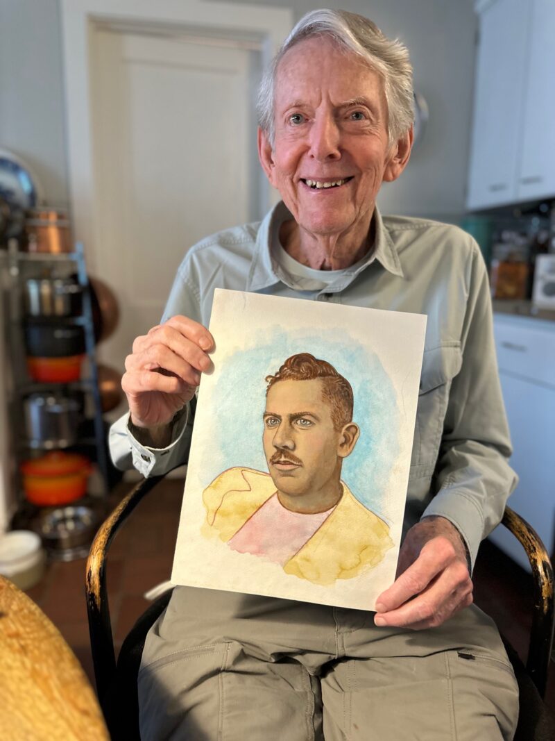 Sag Harbor artist Paul Davis in his kitchen in August 2023 with his portrait of novelist John Steinbeck. ANNETTE HINKLE