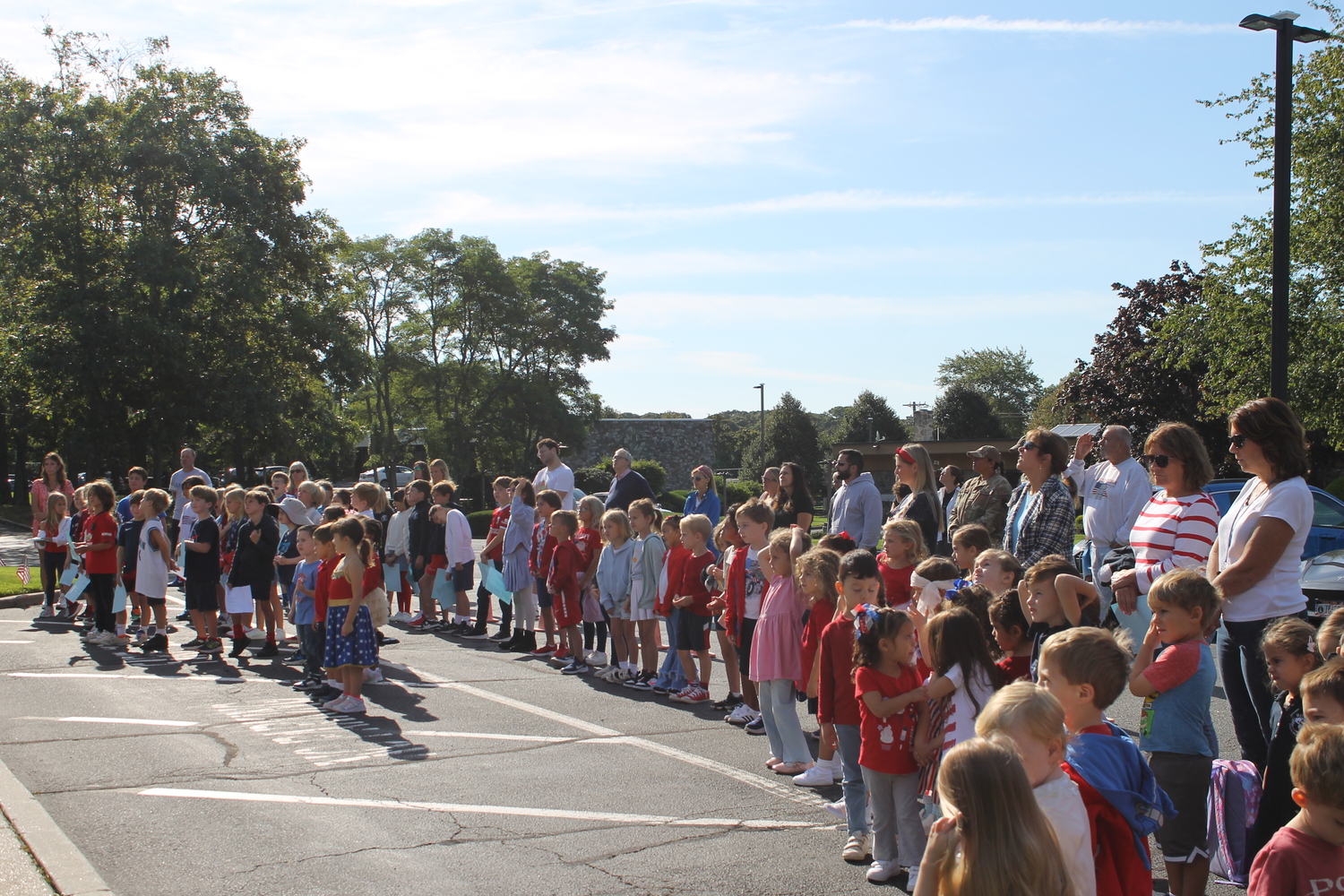 Students and staff at Raynor Country Day School gathered together at the flagpole to commemorate Patriot Day on September 11. The school honored the events of the day with song and spirit with the sixth-grade class leading guests in the Pledge of Allegiance, while music teacher Suzanne Lewis led the gathering in a series of patriotic songs. After a moment of silence, students shared their personal reflections on service and sacrifice. COURTESY RAYNOR COUNTRY DAY SCHOOL