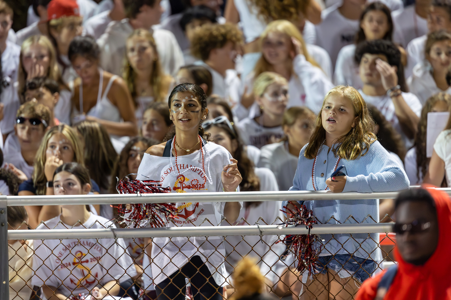 Camryn Ava Mambrino, left, and Peyton Hull watch the game from the large student section that was on hand Friday evening.   SOUTHAMPTON SCHOOL DISTRICT/RON ESPOSITO