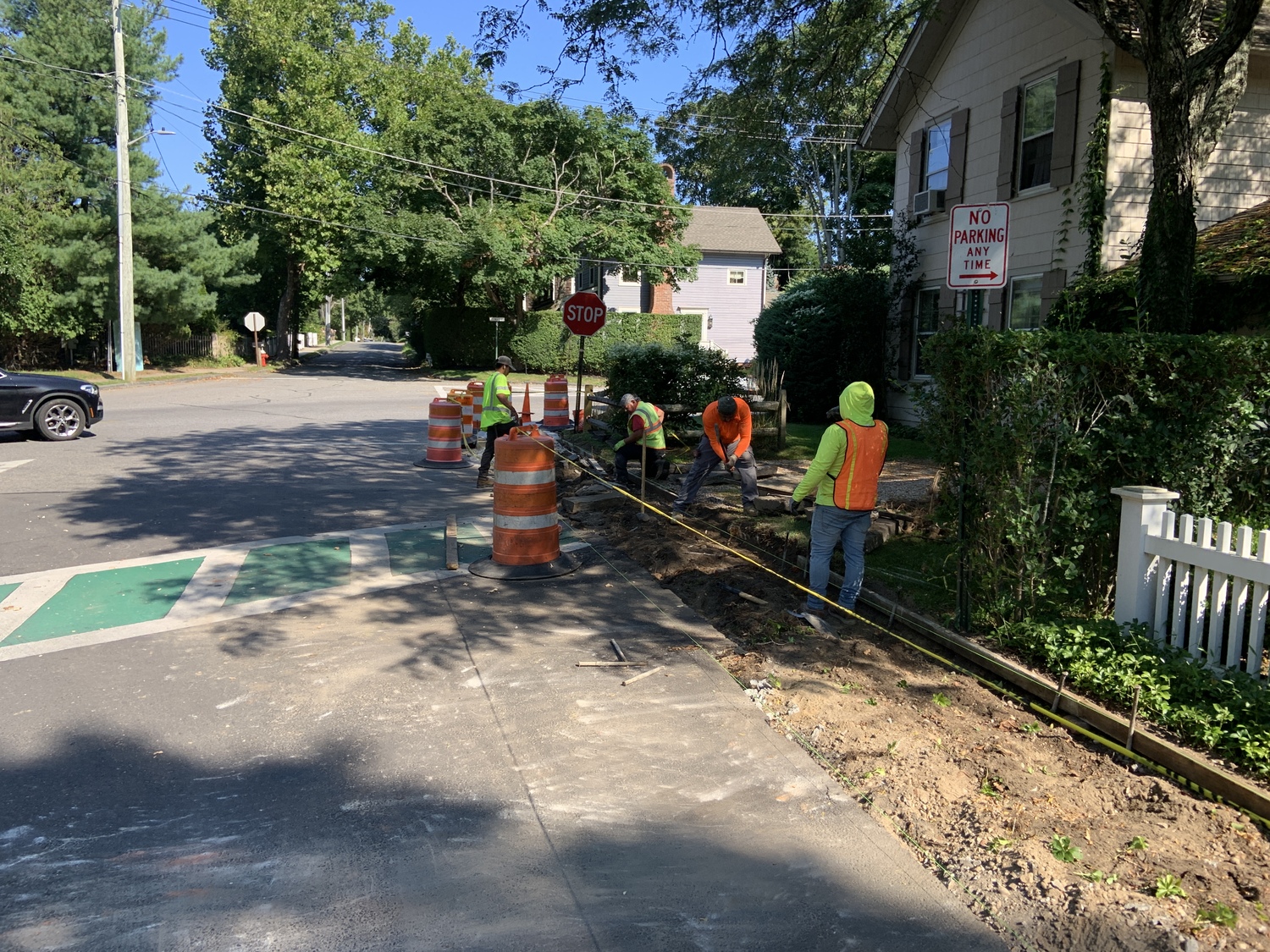 Workers with Long Island Masonry removing old sidewalks along Suffolk Street Extension in Sag Harbor this week. STEPHEN J. KOTZ