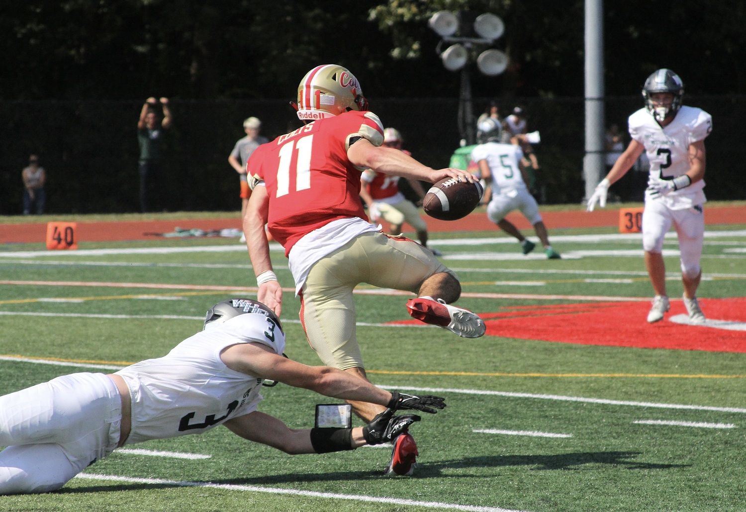 Senior defensive end David Rankin leaps to make a tackle. DESIRÉE KEEGAN