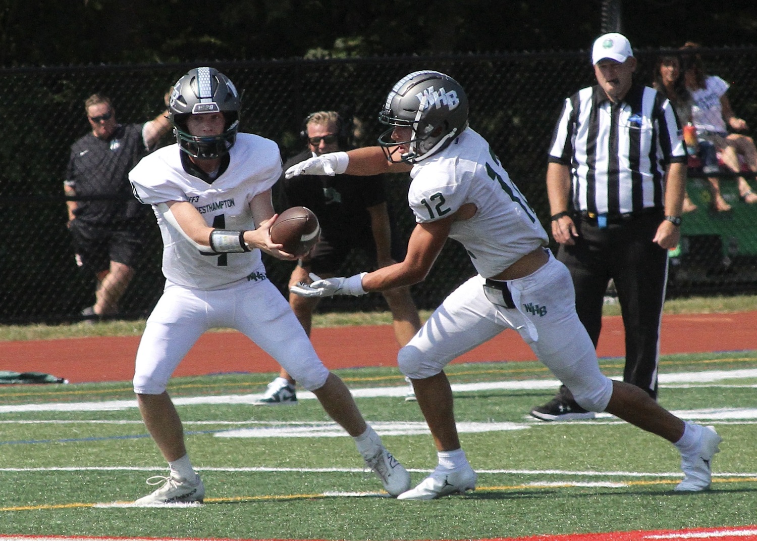 Sophomore quarterback Jake Calloway hands the ball off to senior running back Brody Schaffer. DESIRÉE KEEGAN