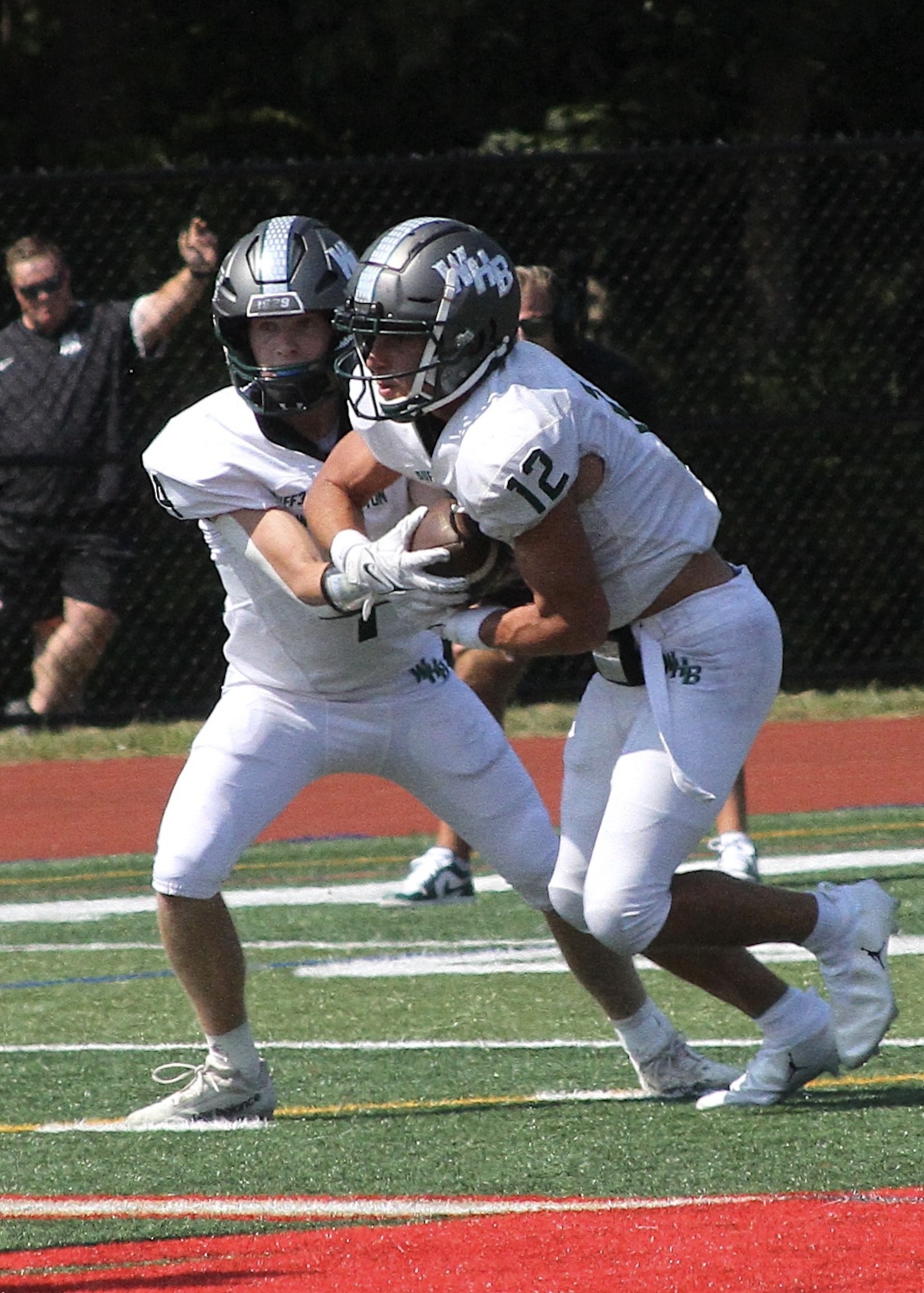 Sophomore quarterback Jake Calloway hands the ball off to senior running back Brody Schaffer. DESIRÉE KEEGAN