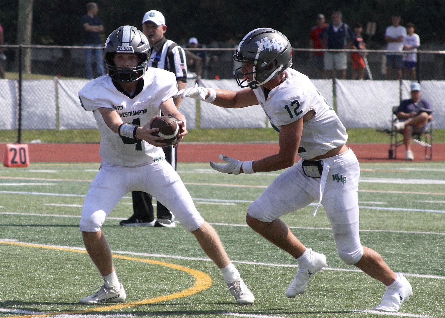 Sophomore quarterback Jake Calloway hands the ball off to senior running back Brody Schaffer. DESIRÉE KEEGAN