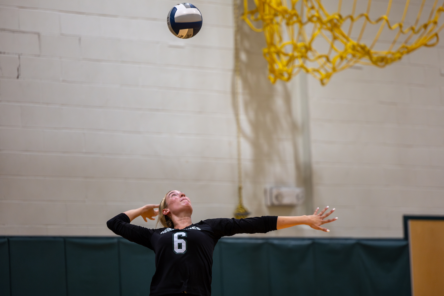 Senior middle hitter Karly Pascale serves in a game against Islip. RON ESPOSITO