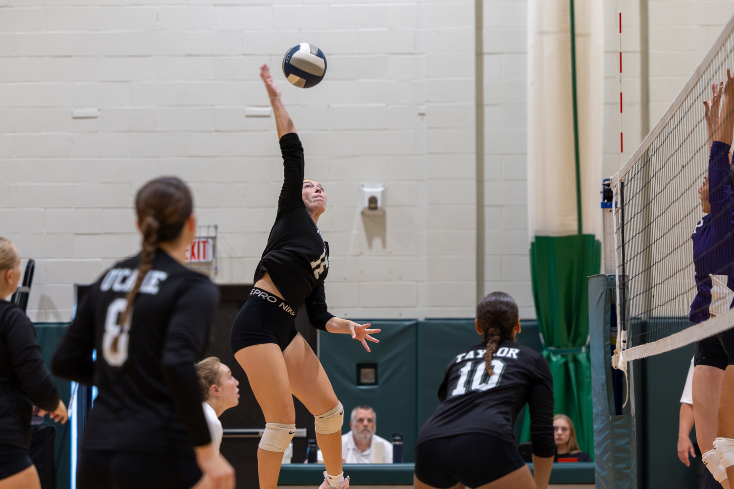 Junior outside hitter Katie Burke spikes the ball in a game against Islip. RON ESPOSITO