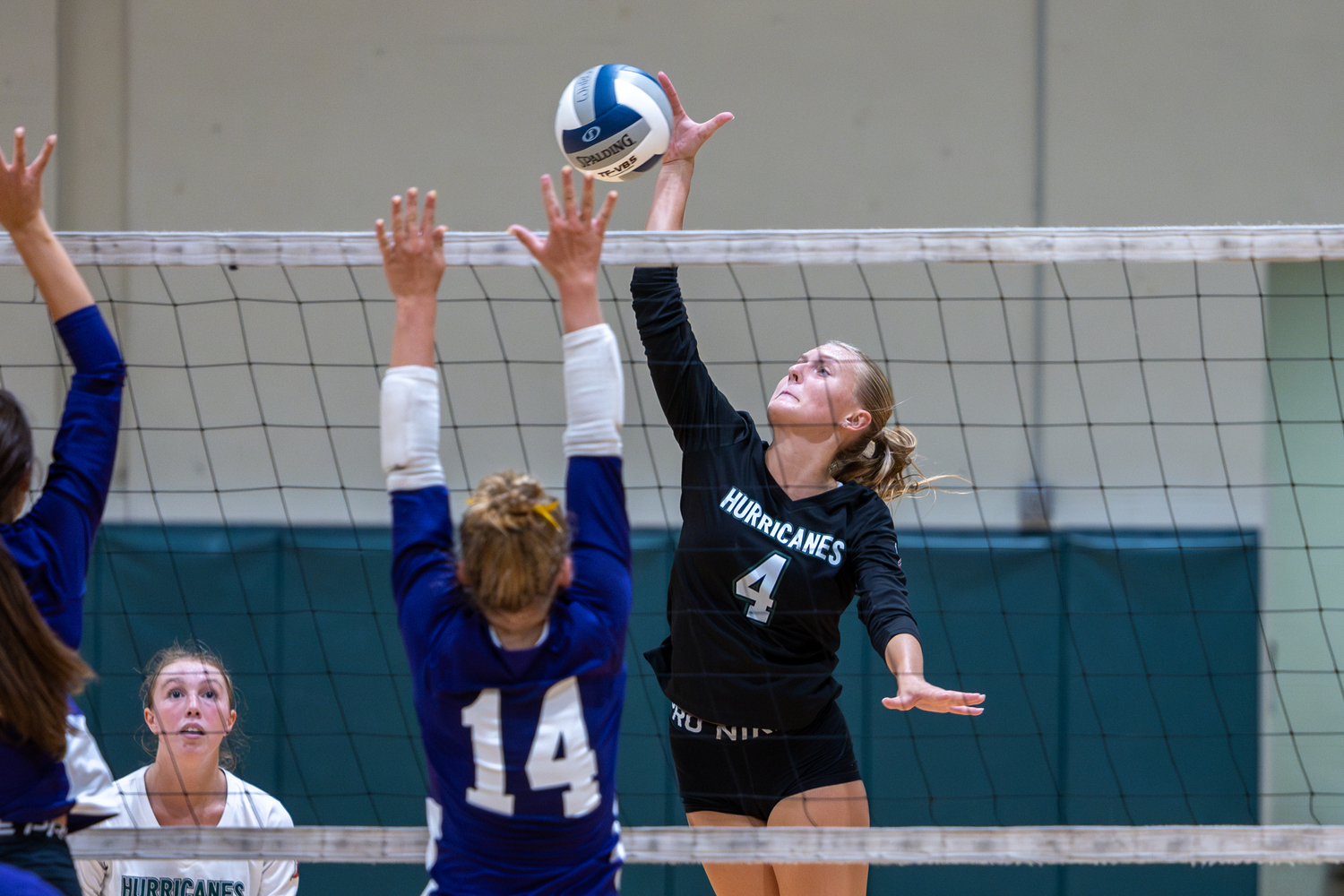 Senior middle Shannon Sweet spikes the ball over the net in a game against Islip. RON ESPOSITO