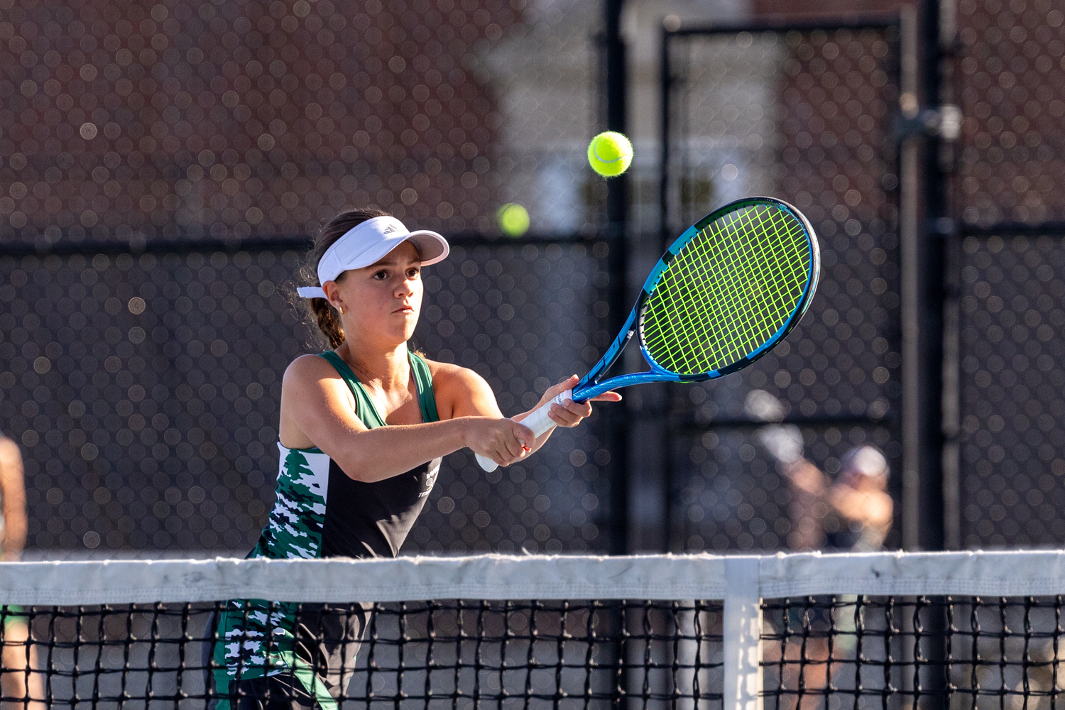 Eight-grader Gabby Arango sends the ball back over the net. RON ESPOSITO