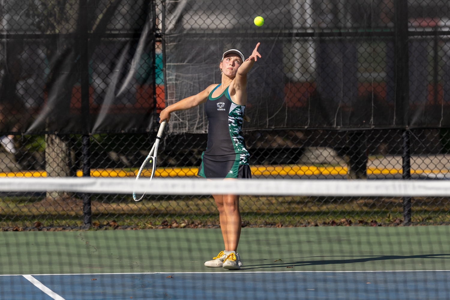 Senior Matilda Buchen serves. RON ESPOSITO