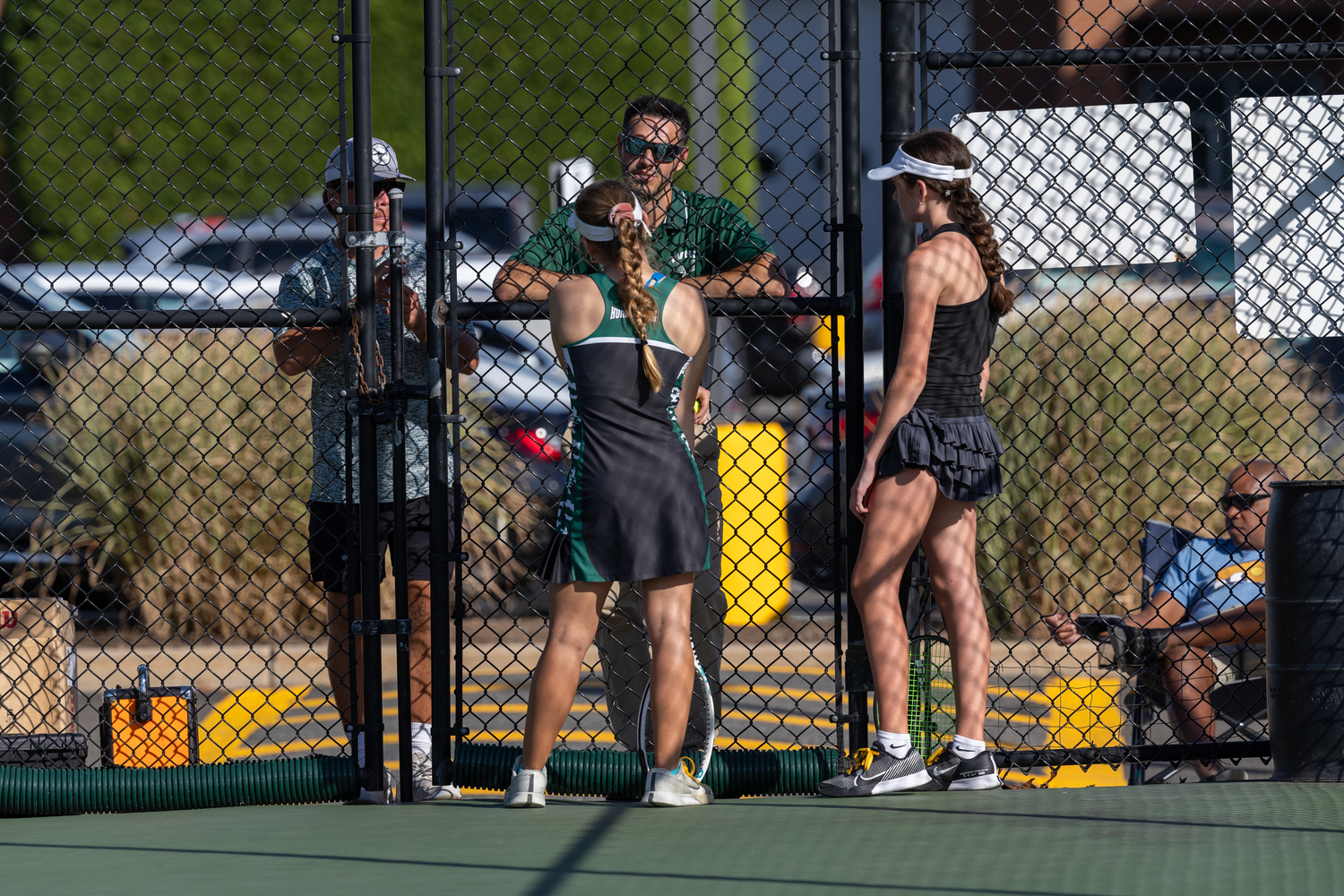 Senior Matilda Buchen and freshman Ava Borruso talk with their coaches. RON ESPOSITO