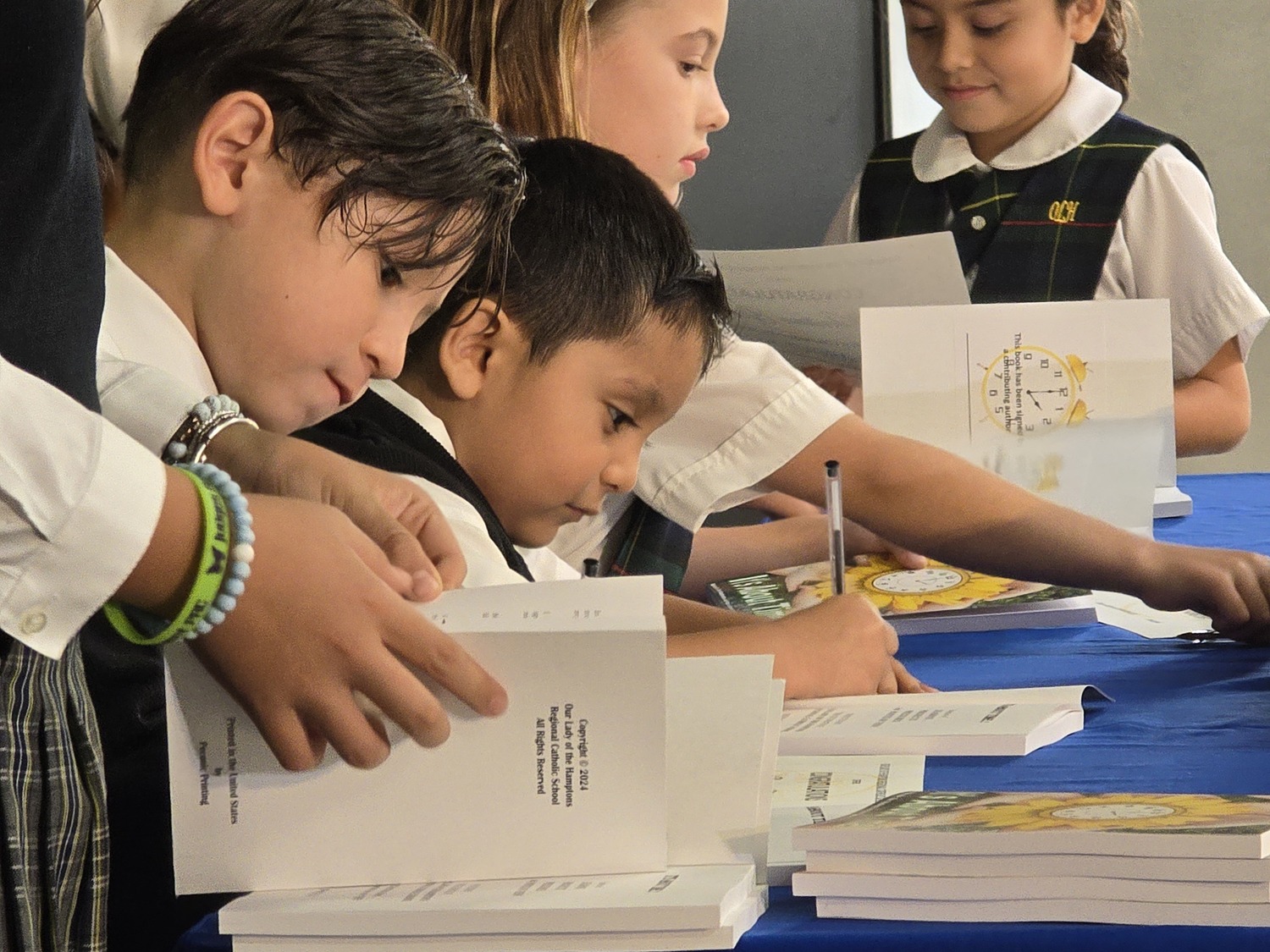 The 200 Our Lady of the Hamptons School students who submitted manuscripts for a recent creative writing project signed their first edition of 