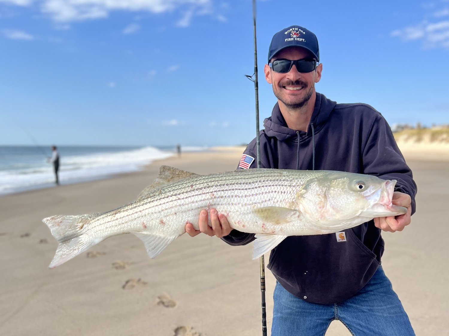 Matt Heckman with a slot-sized striped bass caught off the local beaches recently. The bass population is in dire straits and fisheries managers are considering how they will adjust quotas for 2025 this week.