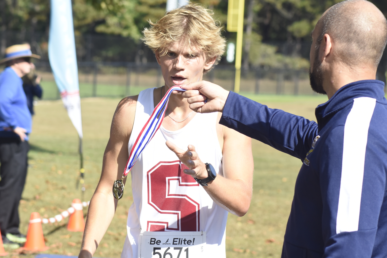 Christian Duggal accepts his medal after winning the race.   DREW BUDD