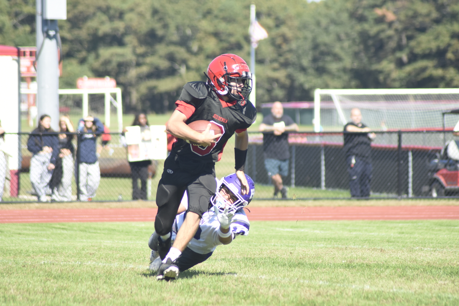 Hampton Bays junior Josh Reyes dives to try to take down Center Moriches freshman Richie Roberts.  DREW BUDD