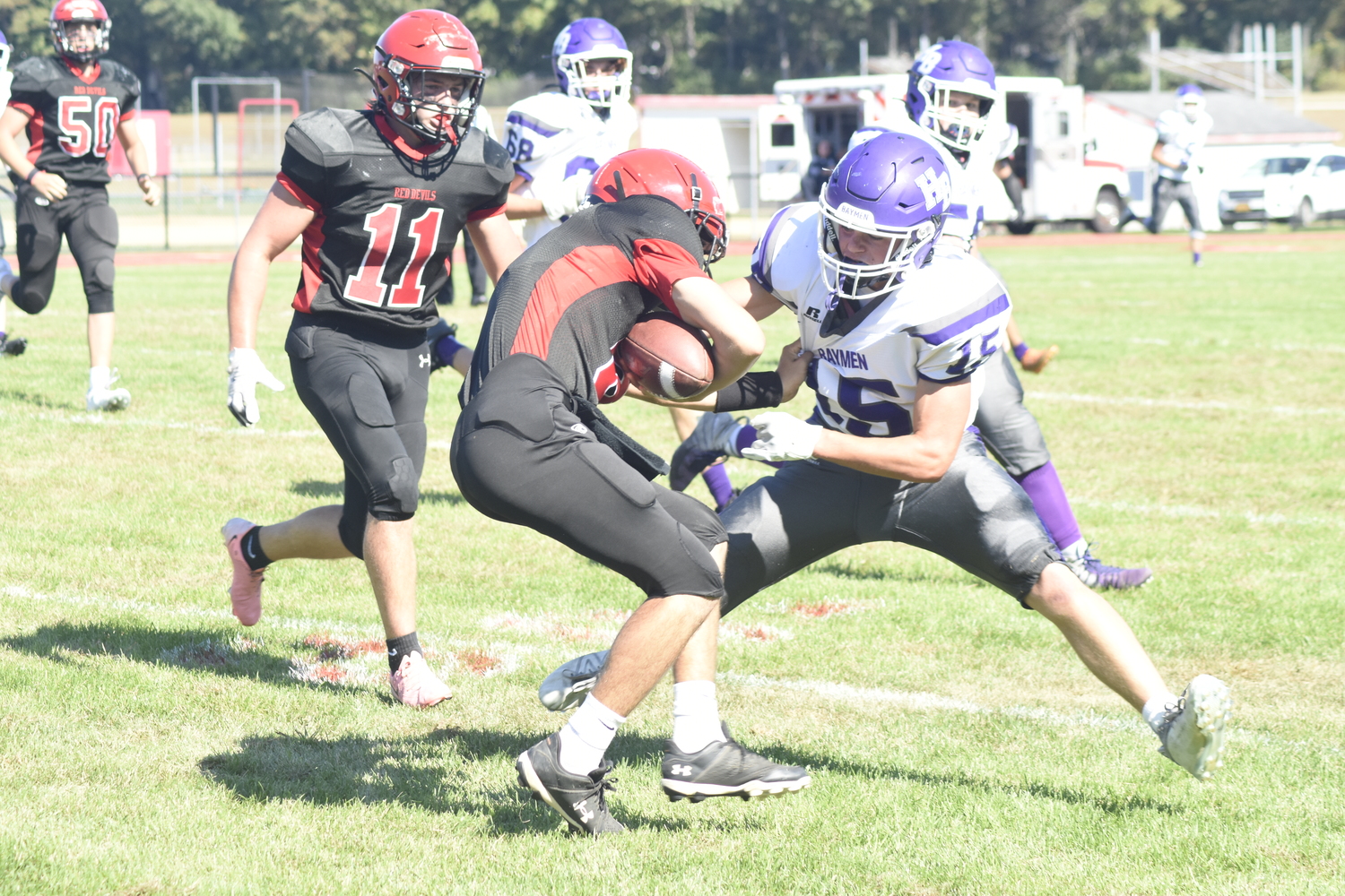 Hampton Bays sophomore Brayden Talmage tries to take down a Center Moriches player.  DREW BUDD