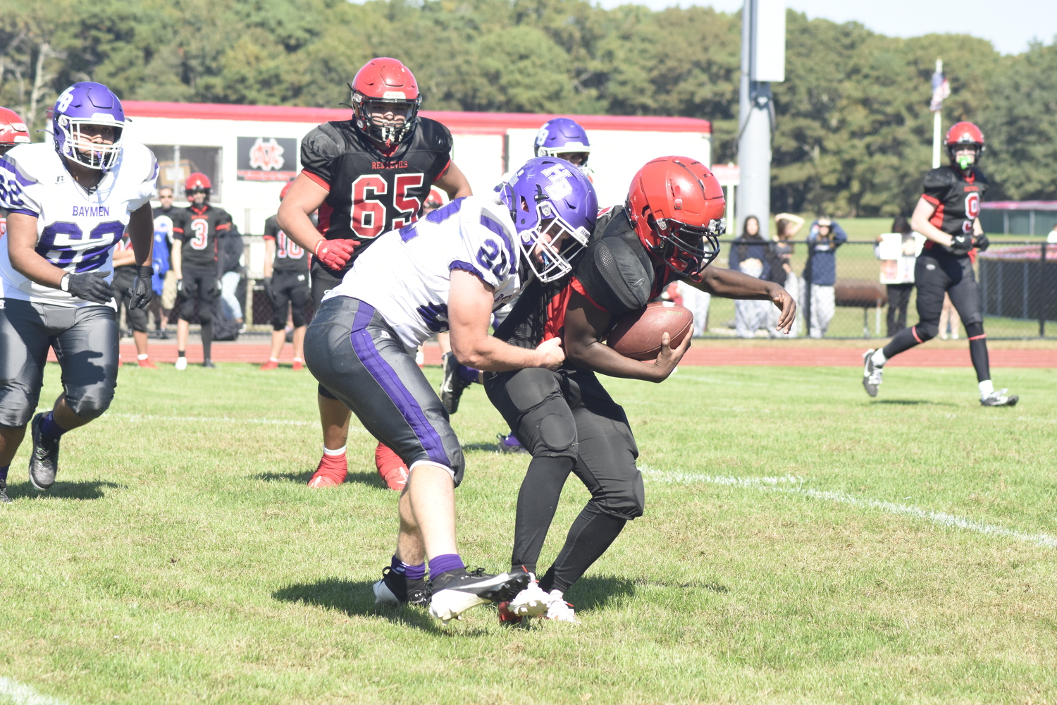 Hampton Bays senior Nate Donahue takes down Center Moriches running back Devin Hayes.   DREW BUDD