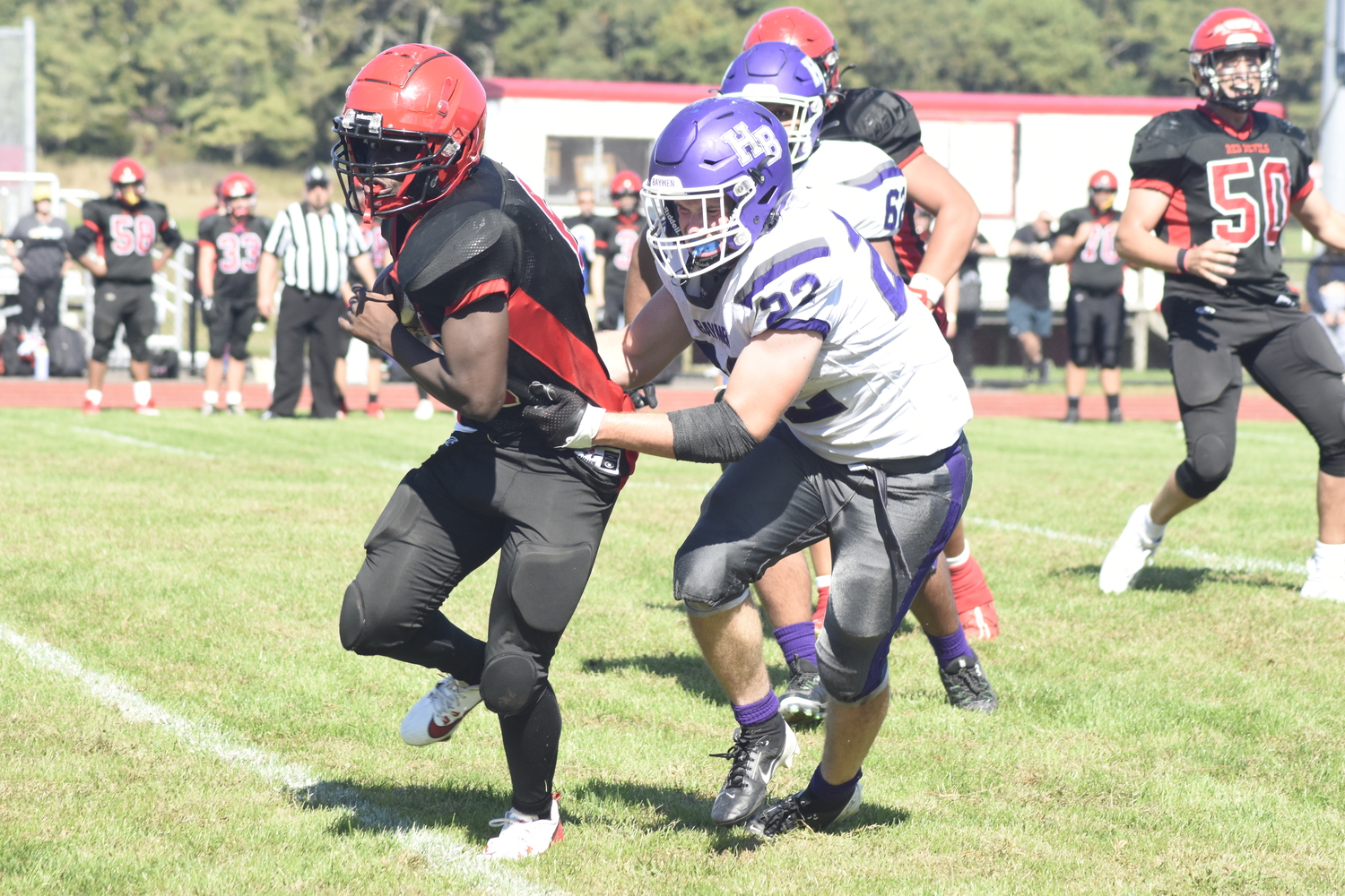 Hampton Bays senior Nate Donahue takes down Center Moriches running back Devin Hayes.   DREW BUDD