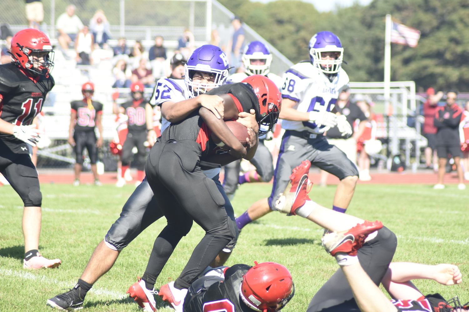 Hampton Bays senior Michael Gutierrez records a tackle.  DREW BUDD