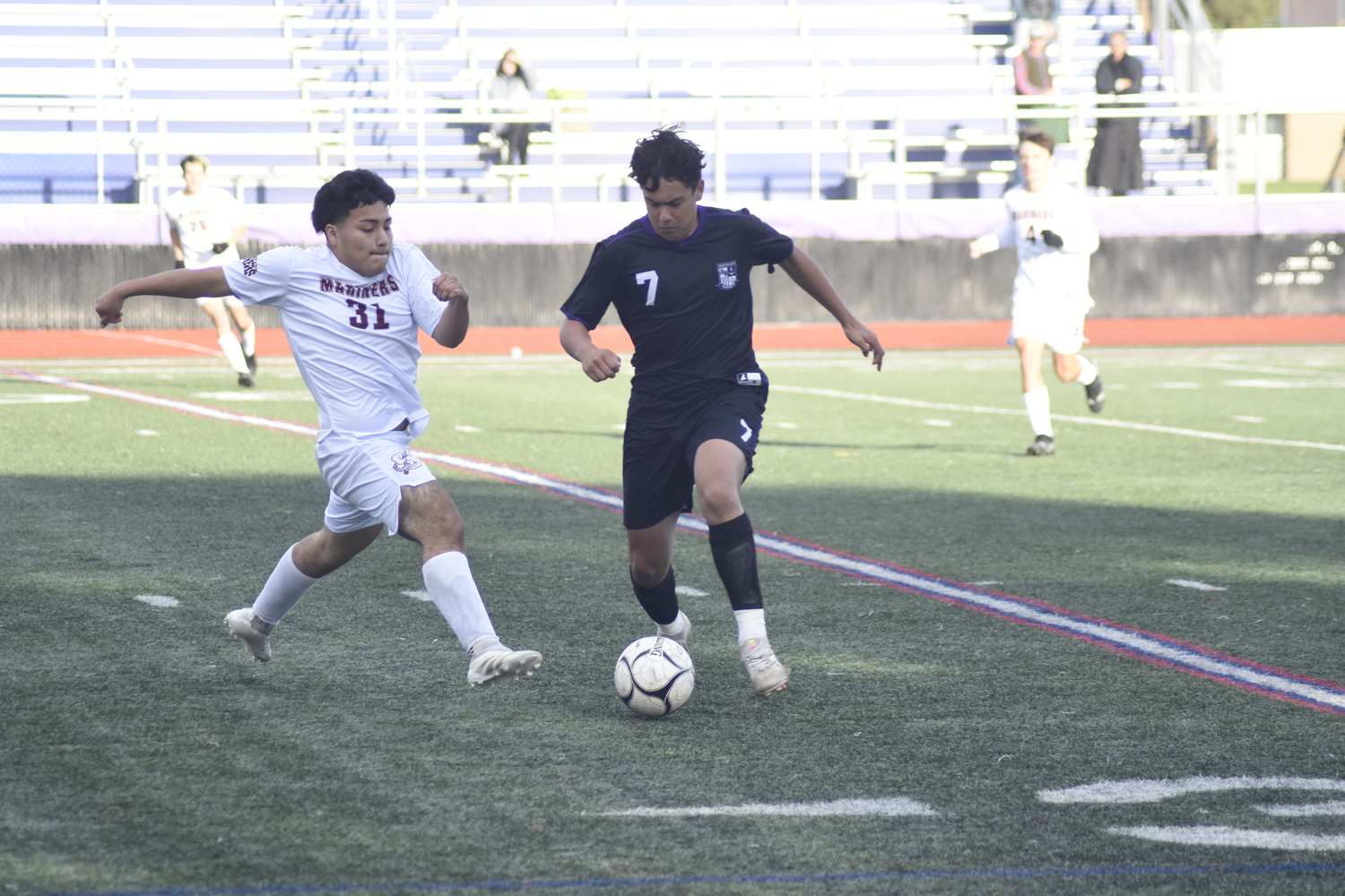 Southampton senior Antony Tenen-Guanga goes after the ball possessed by Hampton Bays senior Edie Cabrera.  DREW BUDD