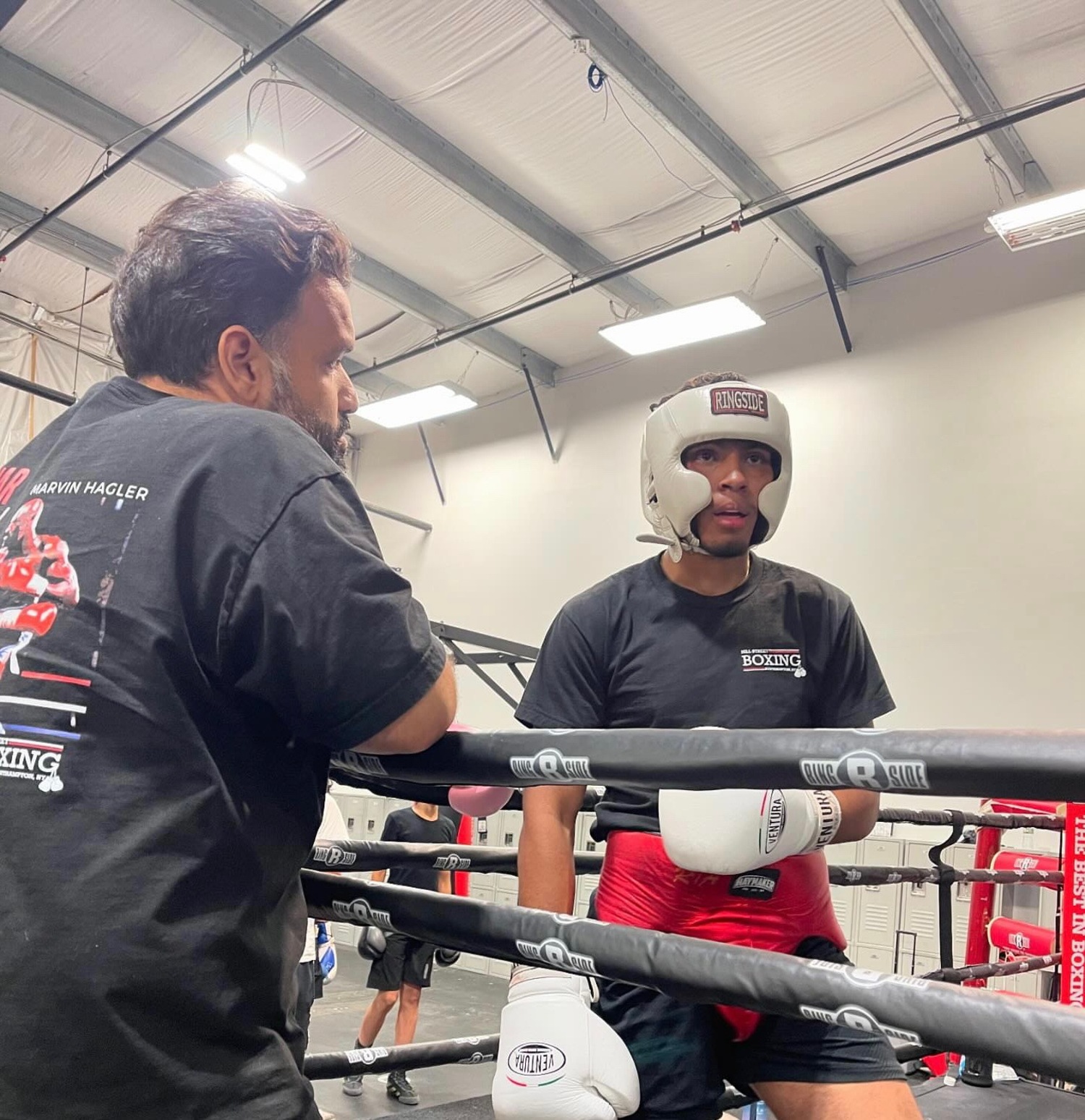 Chris Atancuri gets pointers from Hill Street boxing coach Alan Quinonez. COURTESY CHRIS ATANCURI