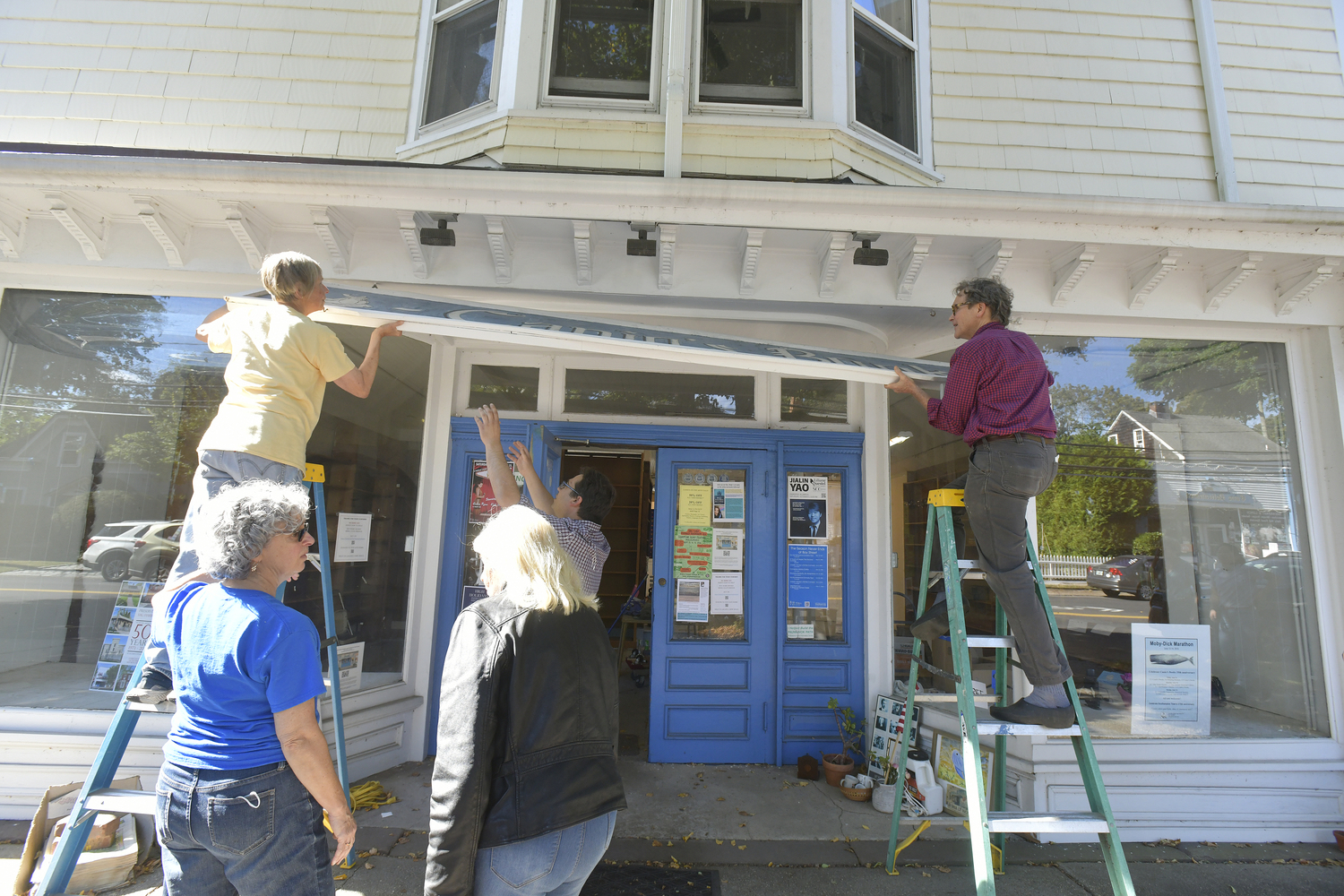 The Canio's Books sign on the front of the Sag Harbor mainstay came down on Monday afternoon marking and end of an era for the storefront and the community.   DANA SHAW