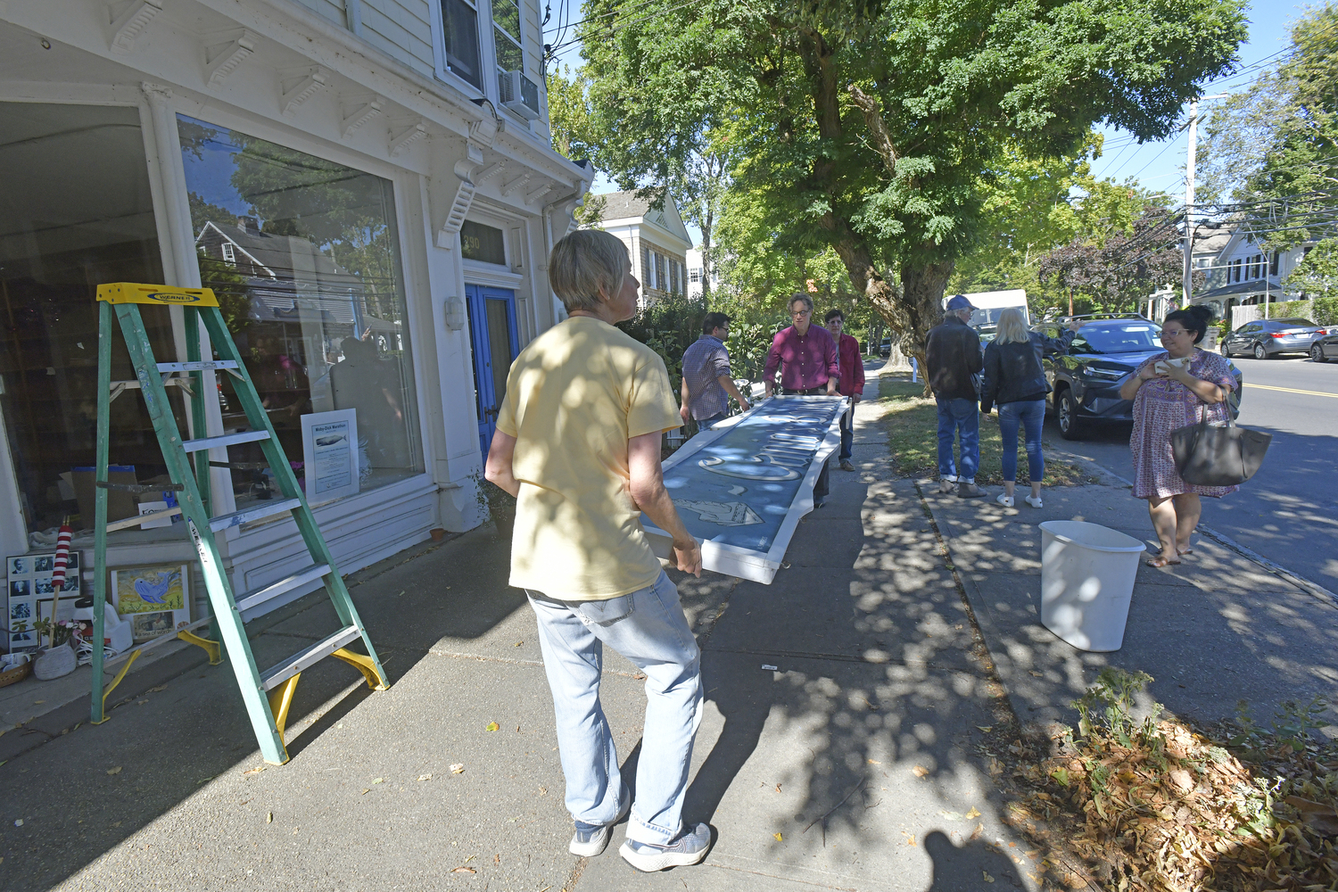 The Canio's Books sign on the front of the Sag Harbor mainstay came down on Monday afternoon marking and end of an era for the storefront and the community.   DANA SHAW