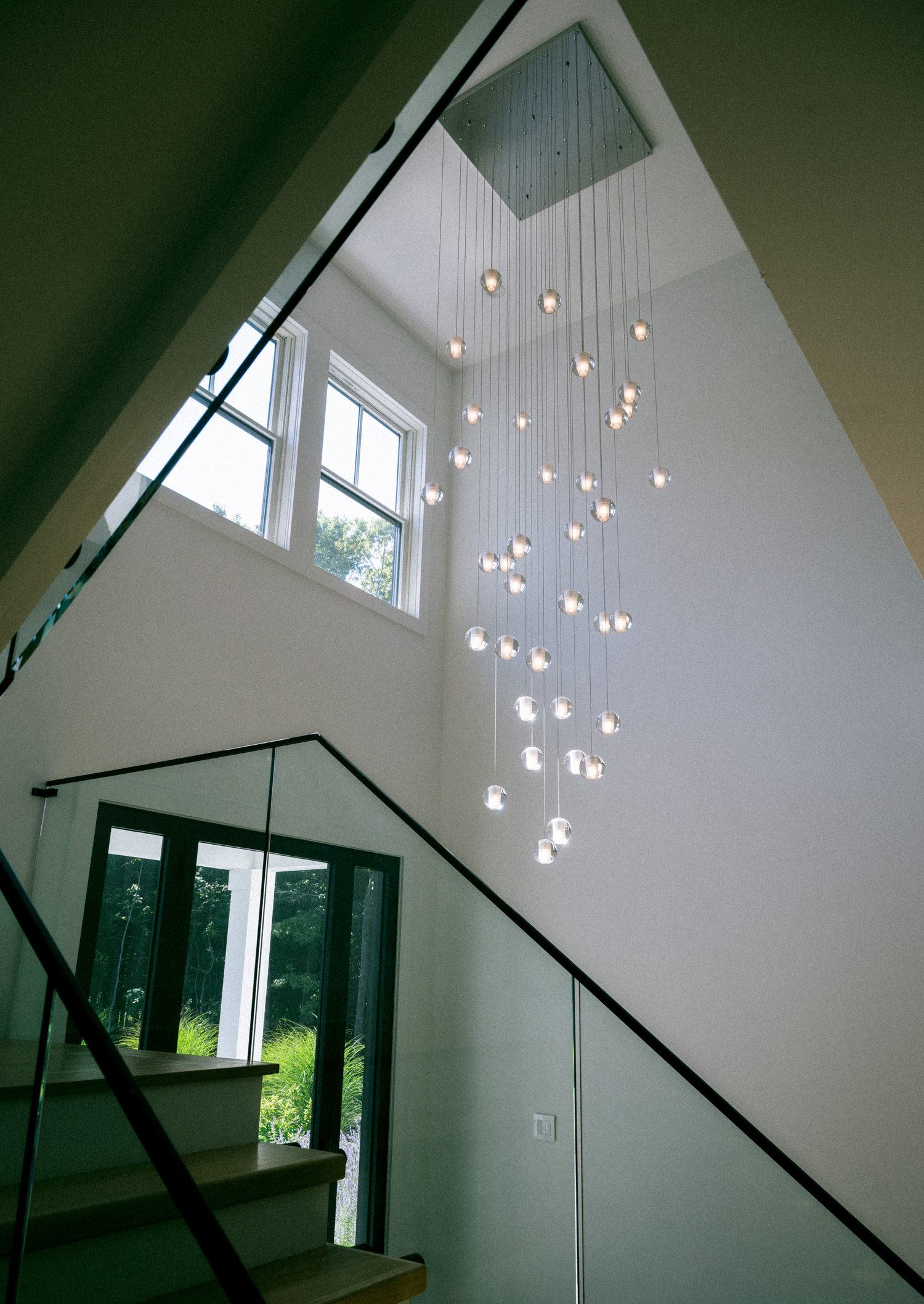 A chandelier mimics rainfall down the main staircase.  MACRAE MARRAN